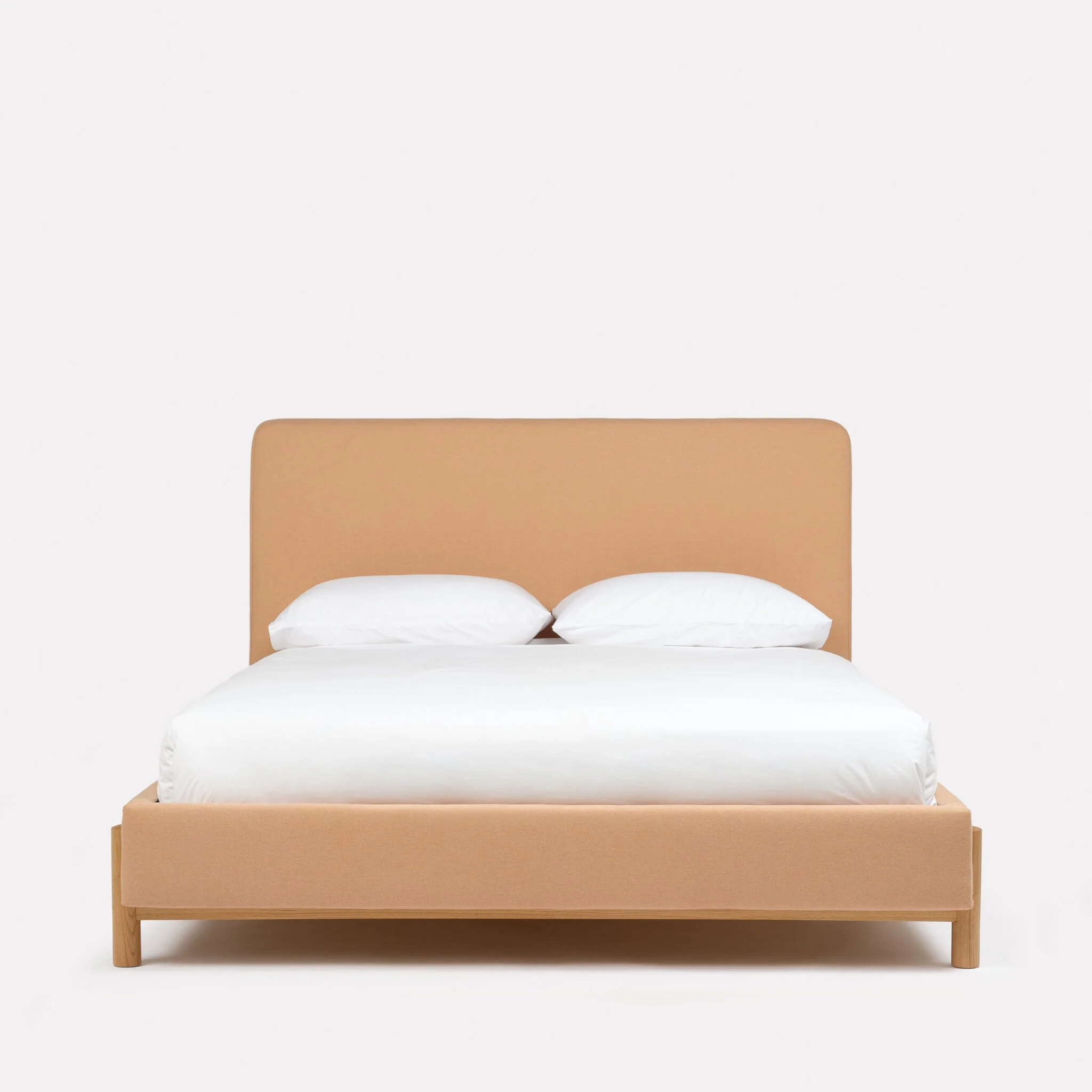Wick Bed by Another Country with upholstered frame and solid oak legs