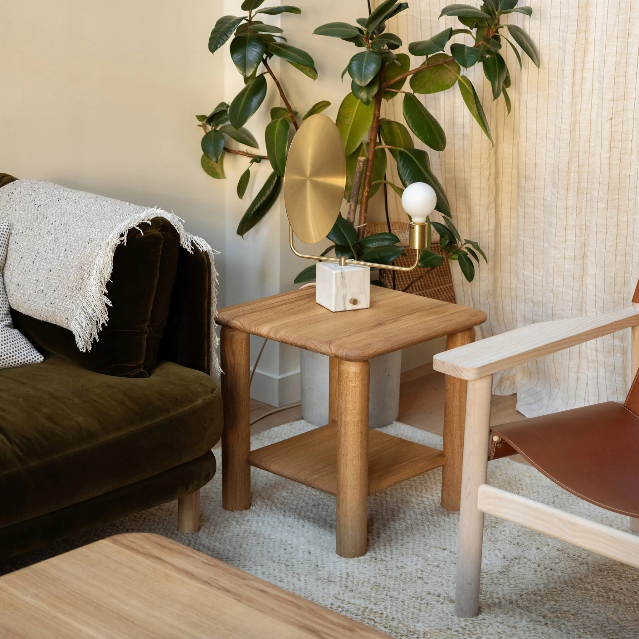 Feld Side Table showing gently curved oak top and integrated lower shelf