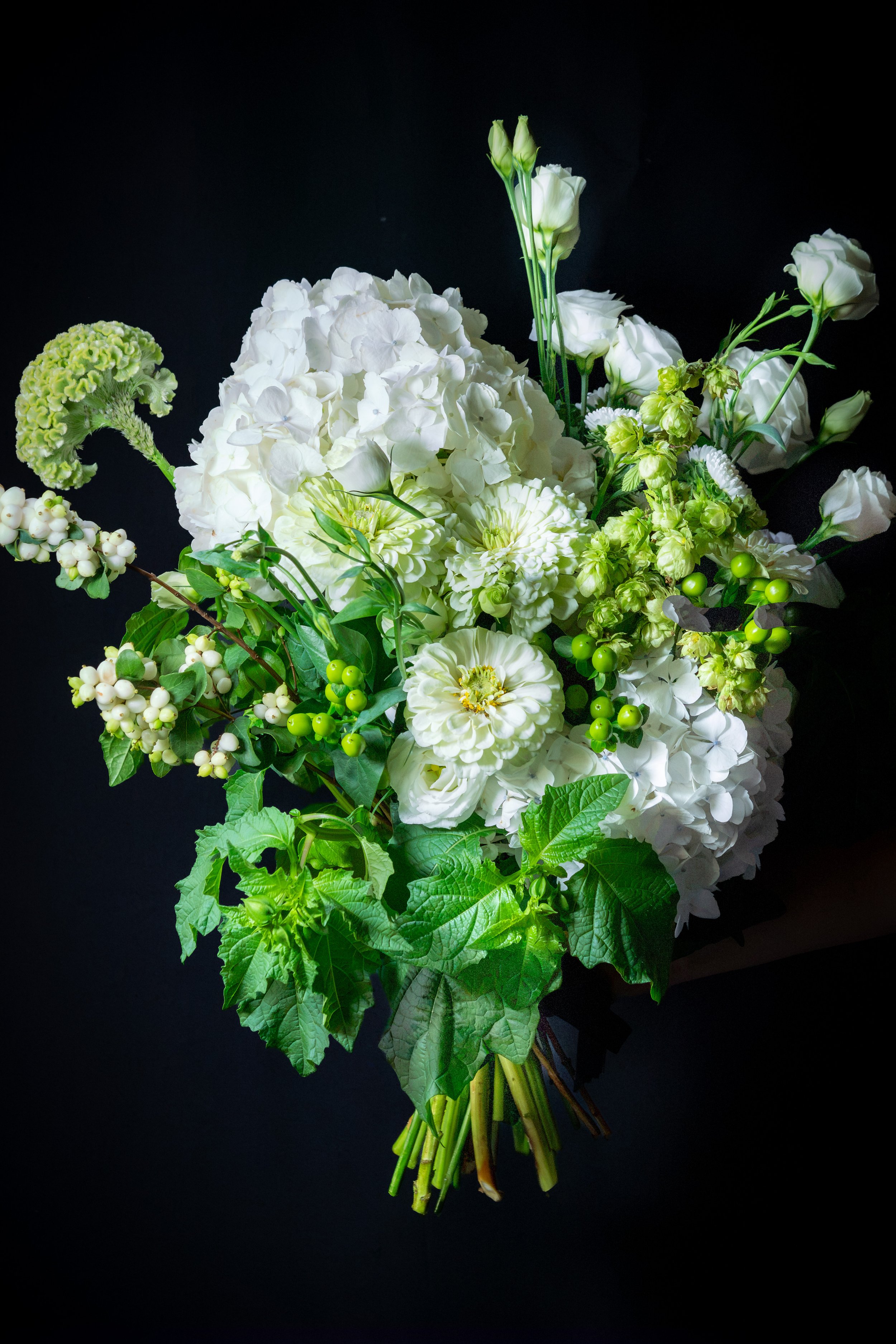 The Pure One – sculptural white and green flower bouquet with layered blooms, berries and expressive seasonal foliage