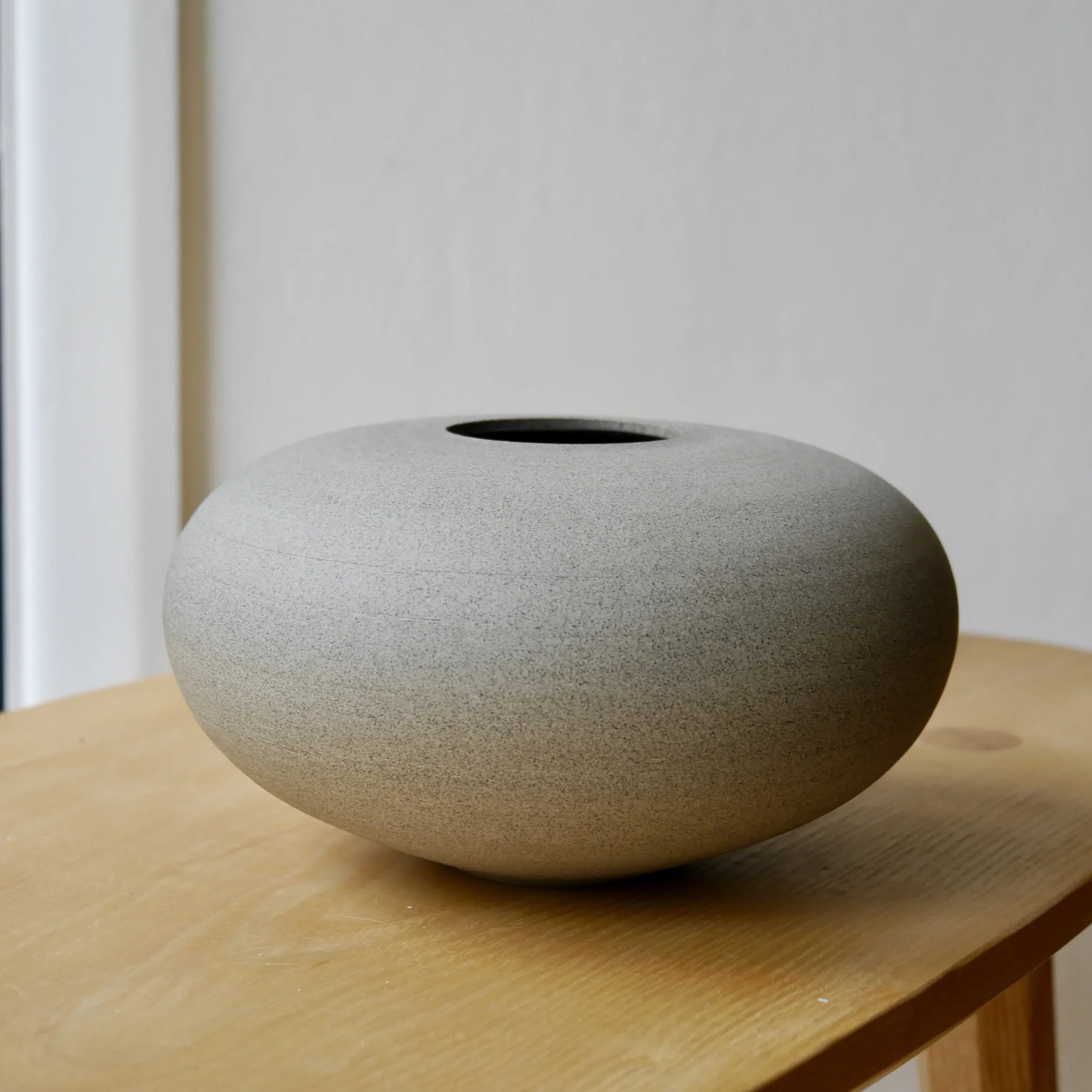 Unglazed stone-coloured clay surface of Throw to Fire Stone Vase