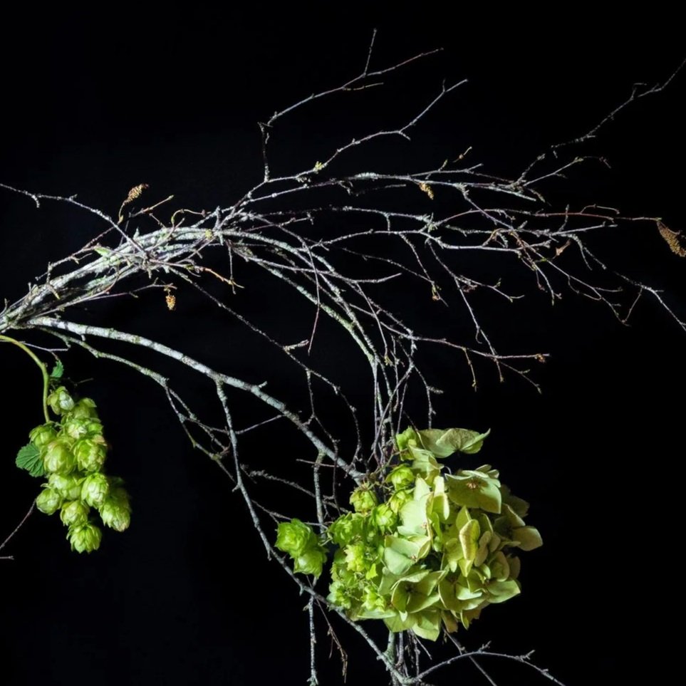 Twisting branches, hops and natural textures forming the open sculptural structure of The Wild One wreath