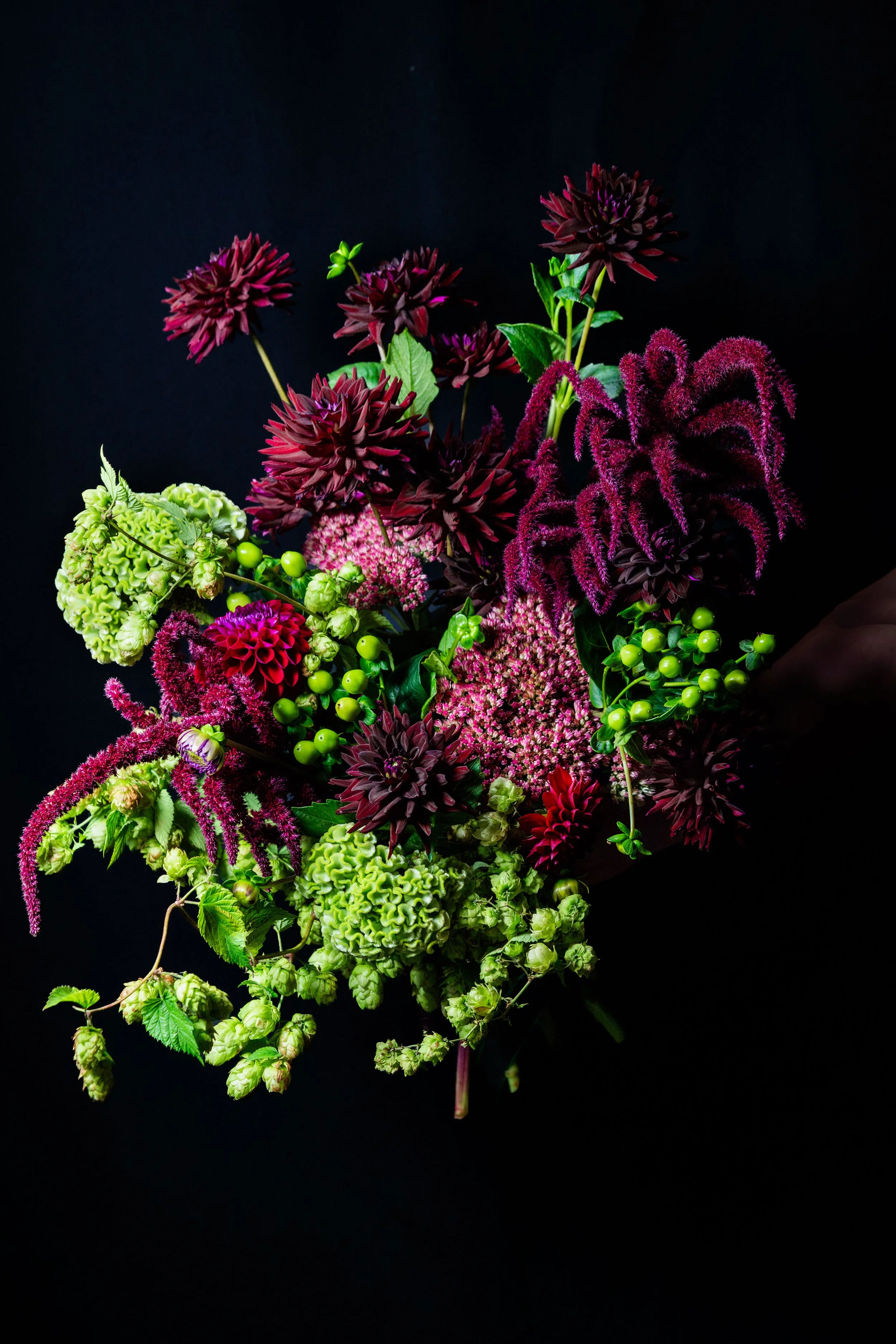 Detail of The Dramatic One showing rich burgundy flowers, berry tones and contrasting fresh green textures