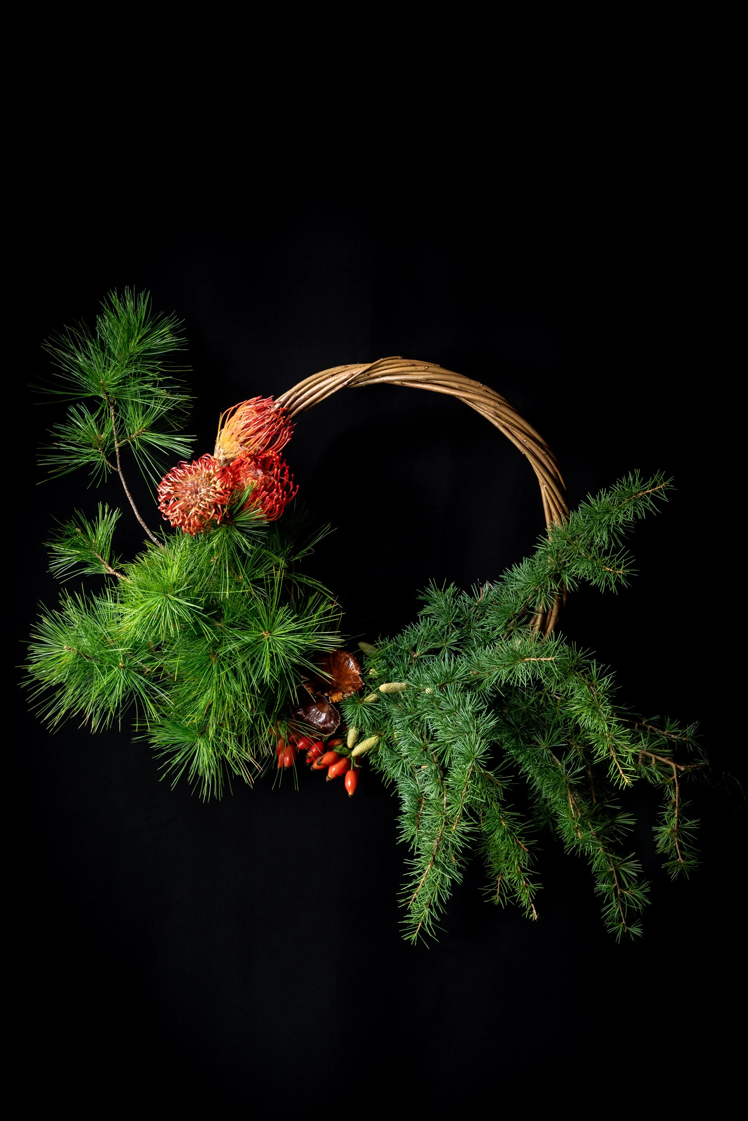 The Winter One – sculptural seasonal wreath with evergreen foliage, pine, berries and natural willow by fōrm&blōm