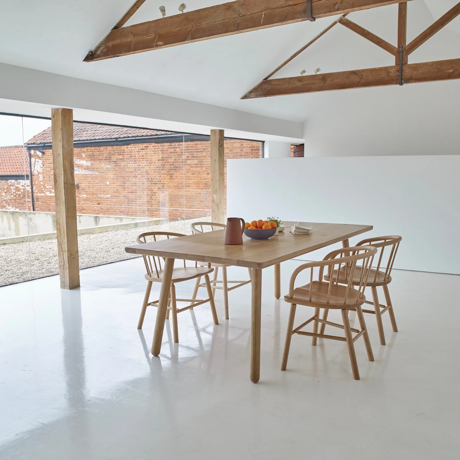 Dining Table ONE by Another Country in a vaulted dining room