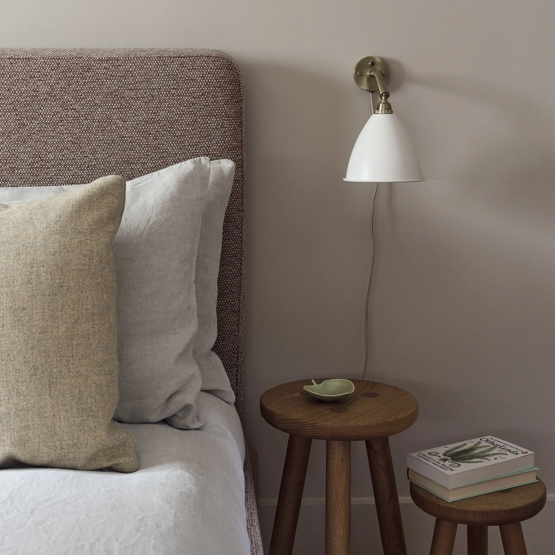 Another Country Wick Bed upholstered in patterned natural fabric