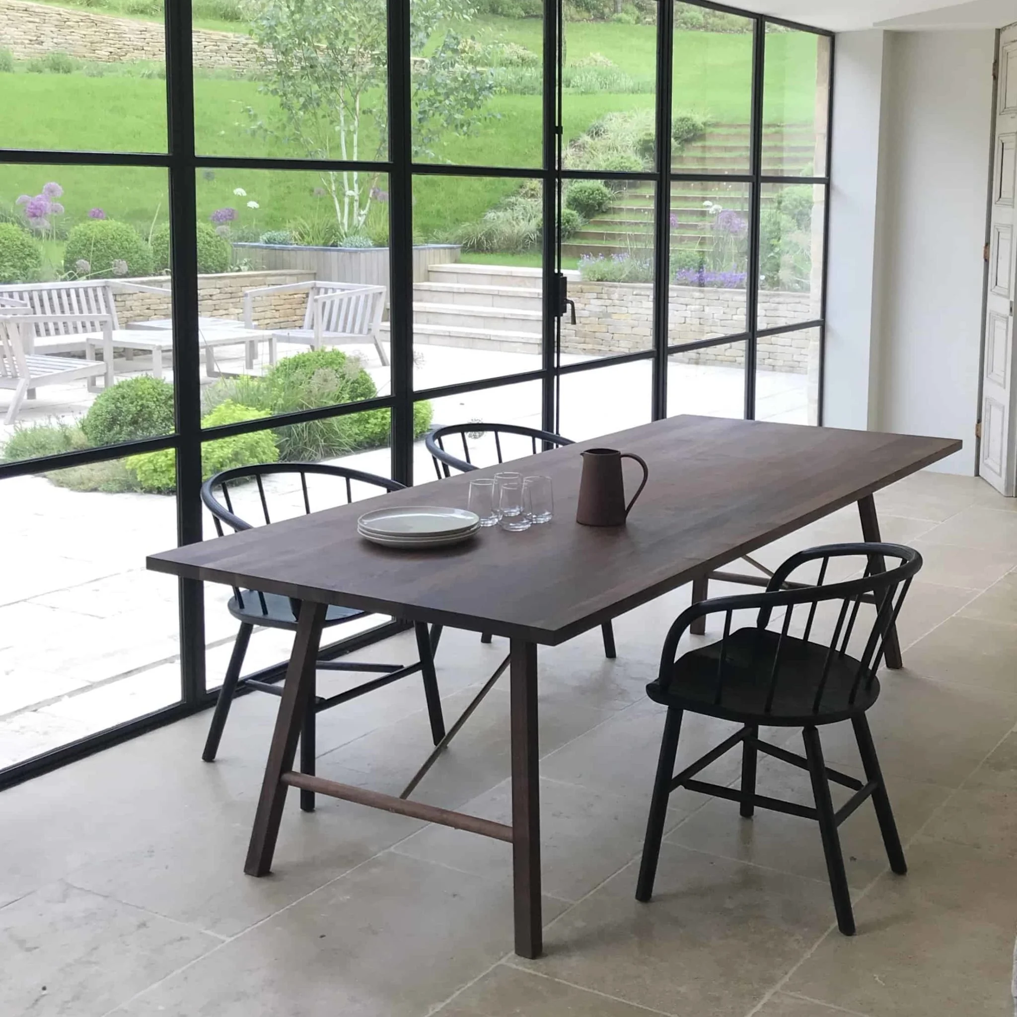 David Irwin Hardy Chair by Another Country in a light flooded dining interior