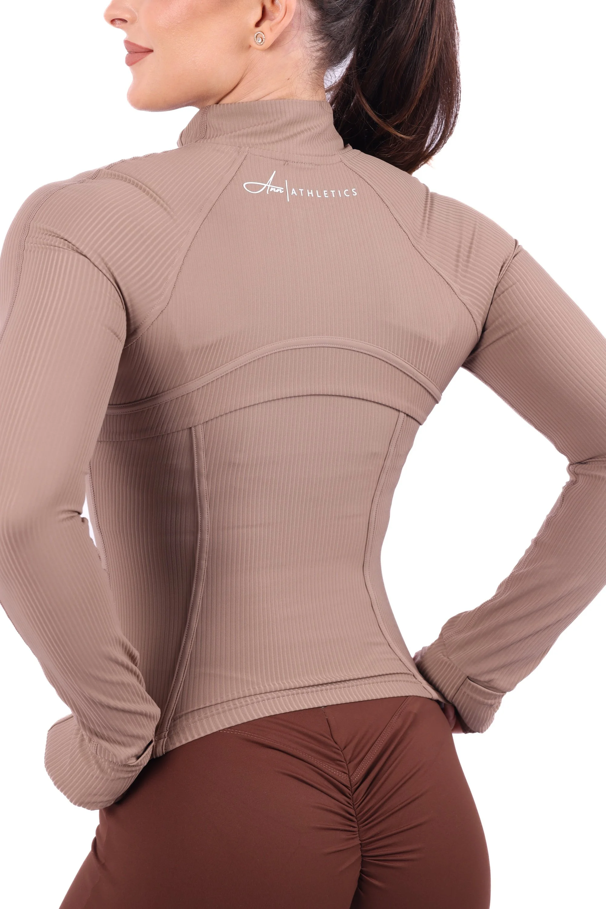 Close-up of the back detailing and Annathletics logo on a taupe long-sleeved activewear top.