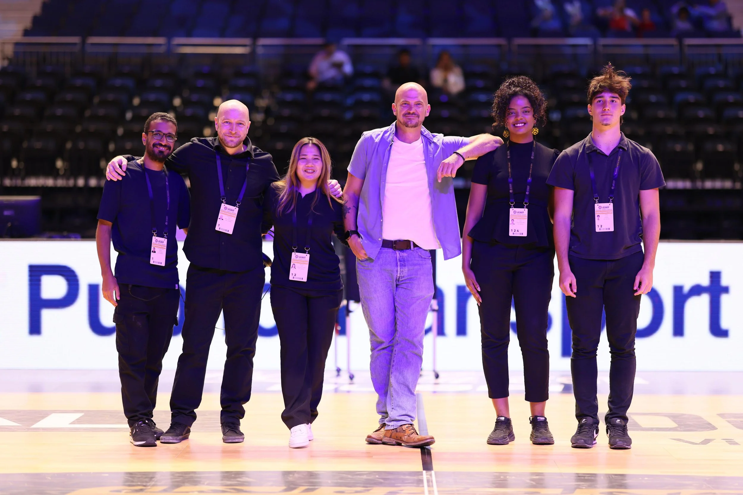 Dan Clark with members of the Dubai Basketball event production team on court at Coca-Cola Arena.