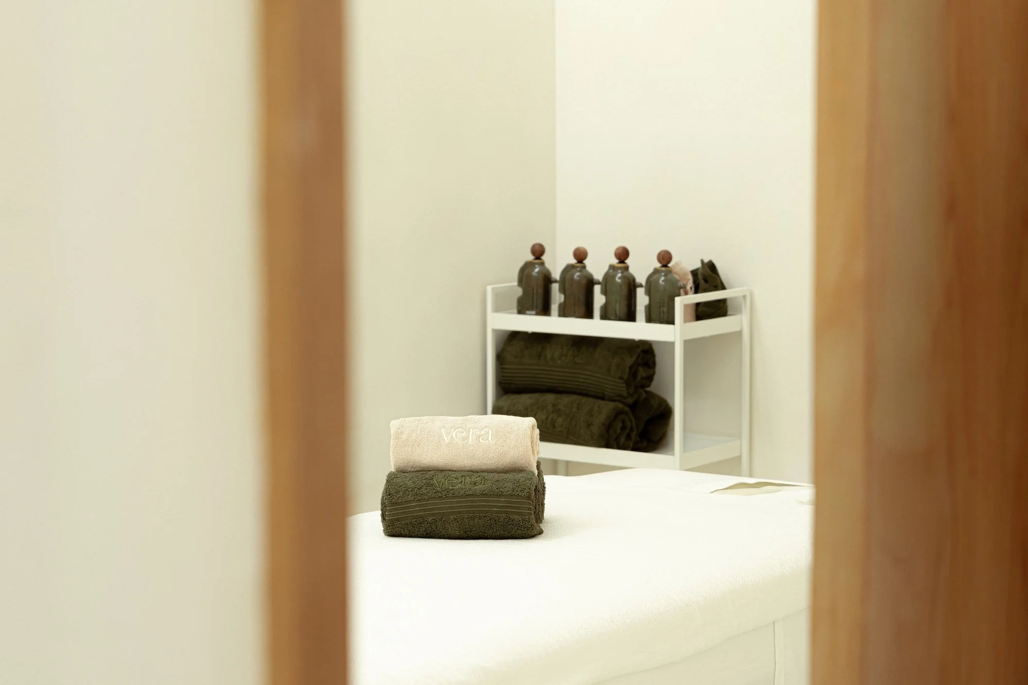 Towels and treatment products arranged inside a private treatment room at Vera Wellness.