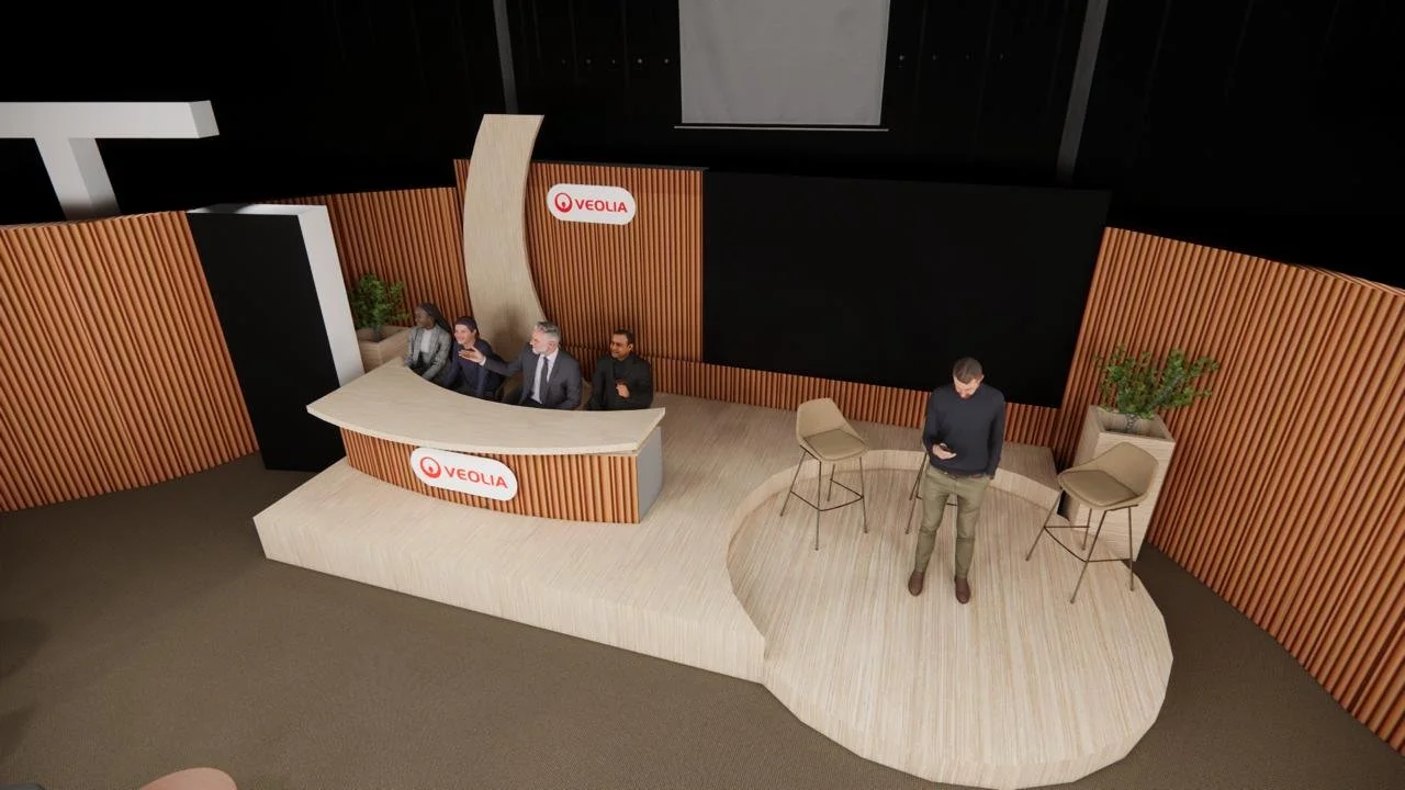 A detailed 3D visualisation of the conference stage, including the panel desk, speaker platform, presentation screen, curved timber elements and Veolia branding.