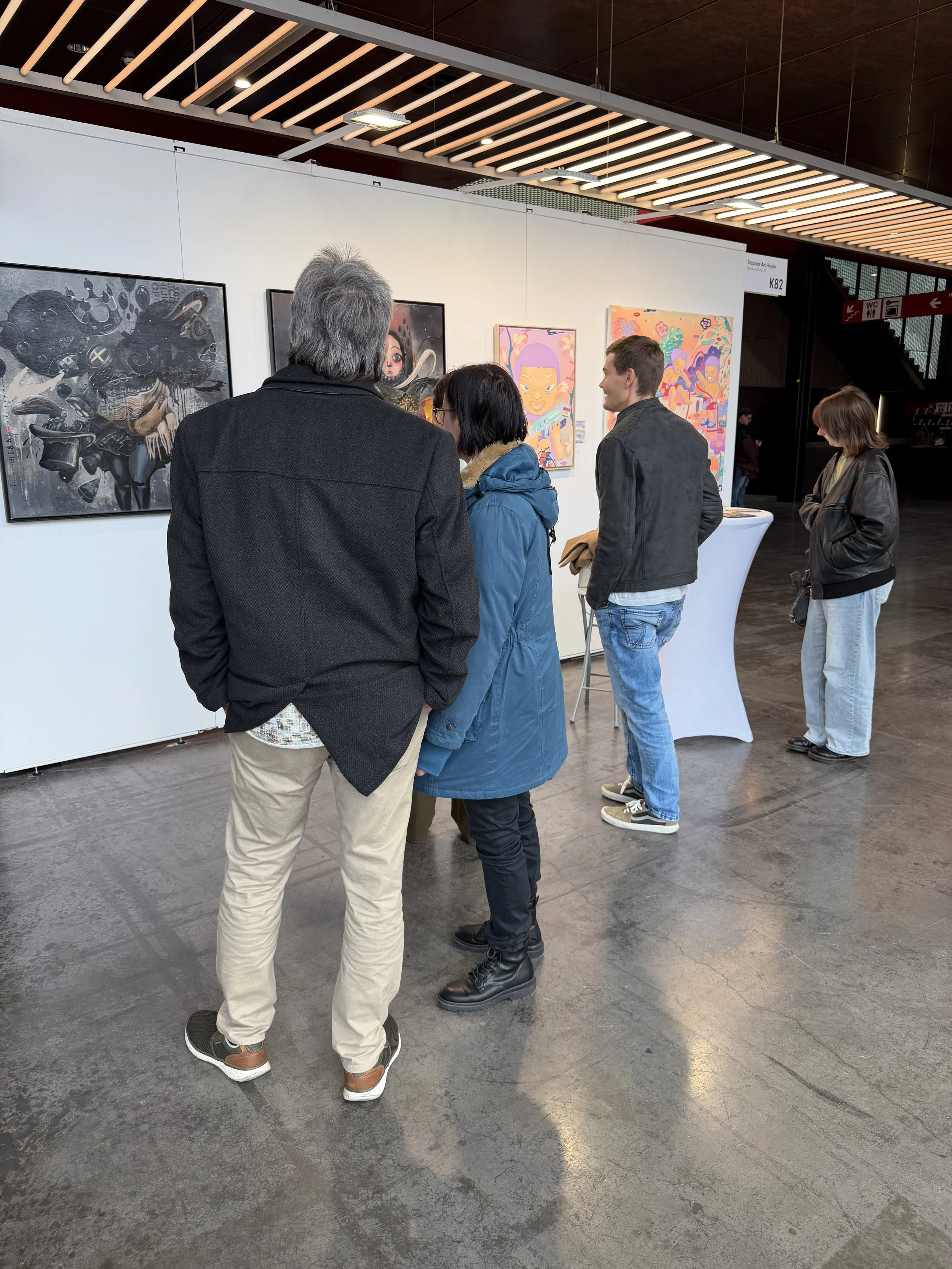People viewing artwork in an art gallery.