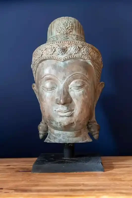 Stone buddha head statue at Woll Estate