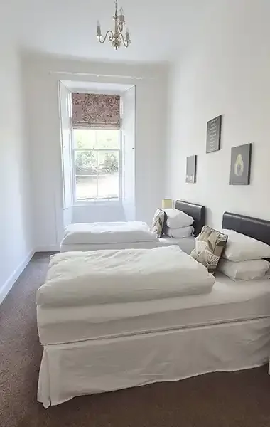 woll-estate-retreats-garden-flat-twin-bedroom.webp
