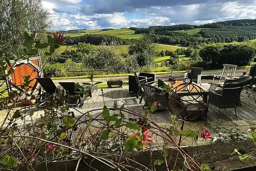 Woll House garden deck with dining space looking over Scottish Border hills