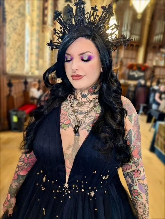 Gothic makeup look with deep purple eyeshadow and dramatic black waved hair — alternative makeup artist Sira Rose