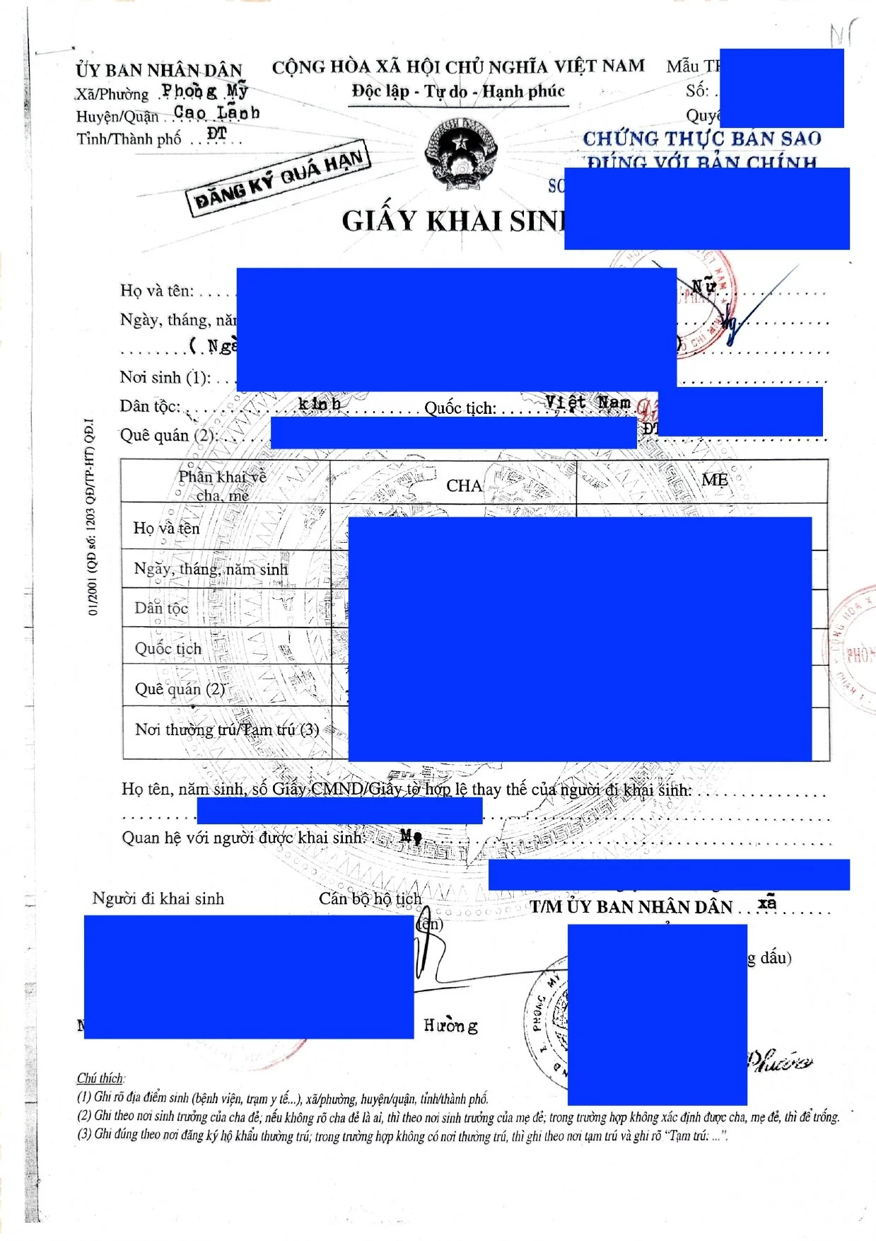 Vietnamese birth registration form with handwritten information, official stamps, and signatures, with certain details redacted in blue.