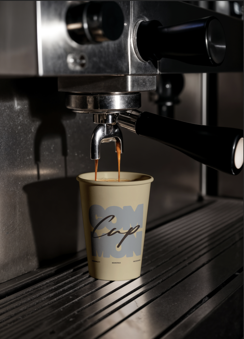 Coffee is being brewed from an espresso machine into a cup with words 'Capp' written on it.