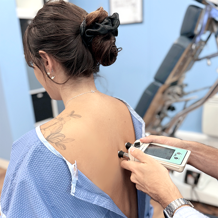 Gonstead Chiropractor using nervoscope on patient.