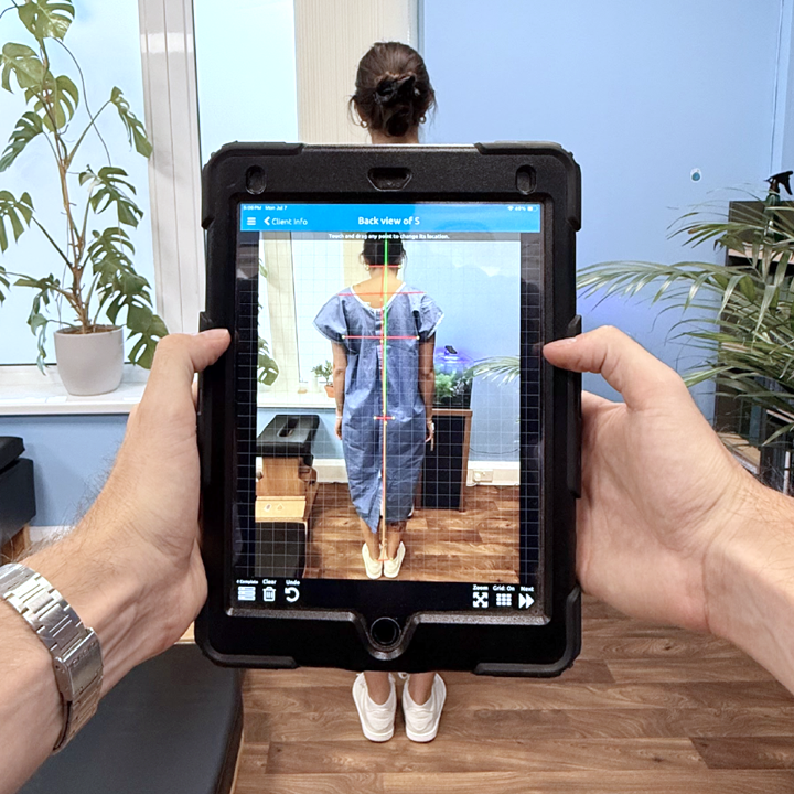Gonstead Chiropractor taking posture picture of patient.