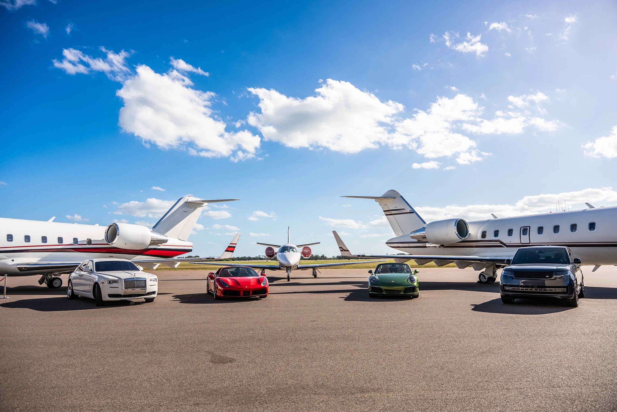 Fleet of vehicles in front of private aircraft