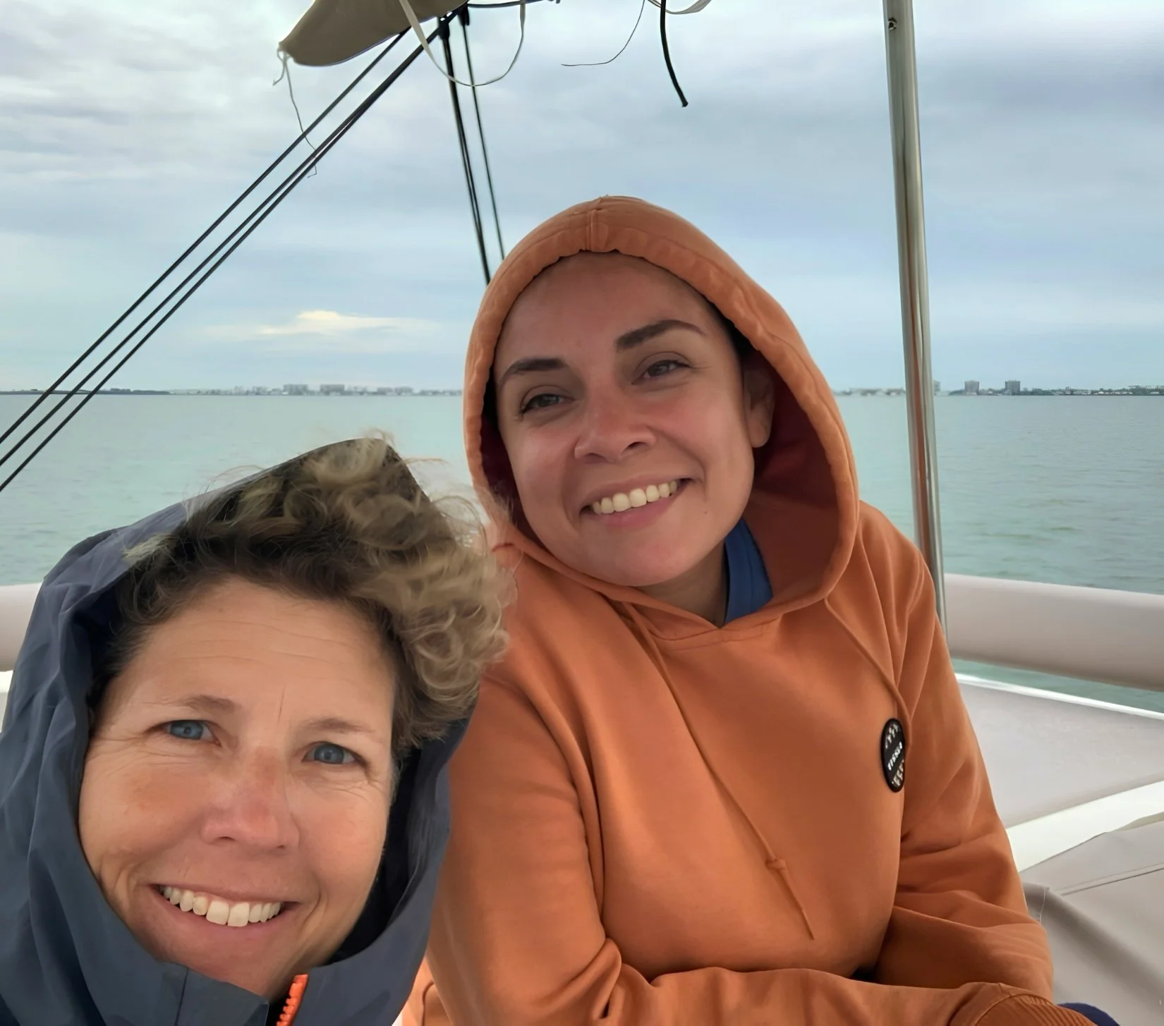 A friendly instructor guiding guests aboard a sailboat