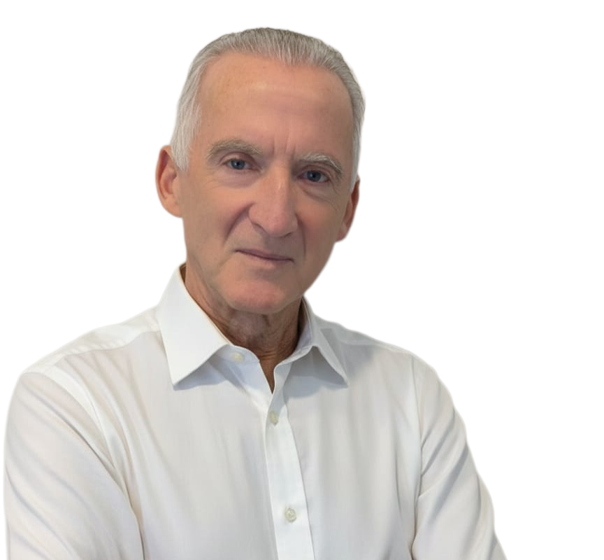 Portrait of an older man with gray hair, wearing a white button-up shirt, looking confidently at the camera.