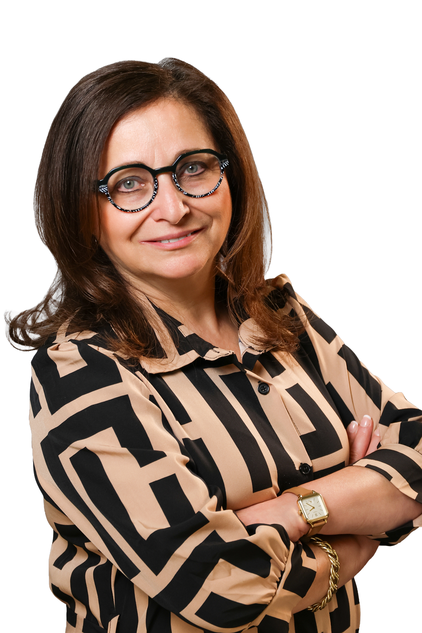Kathy Laszlo with long brown hair, wearing round glasses with red and tortoiseshell frames, a pinkish-red blouse with pleats, and a silver necklace, smiling at the camera.