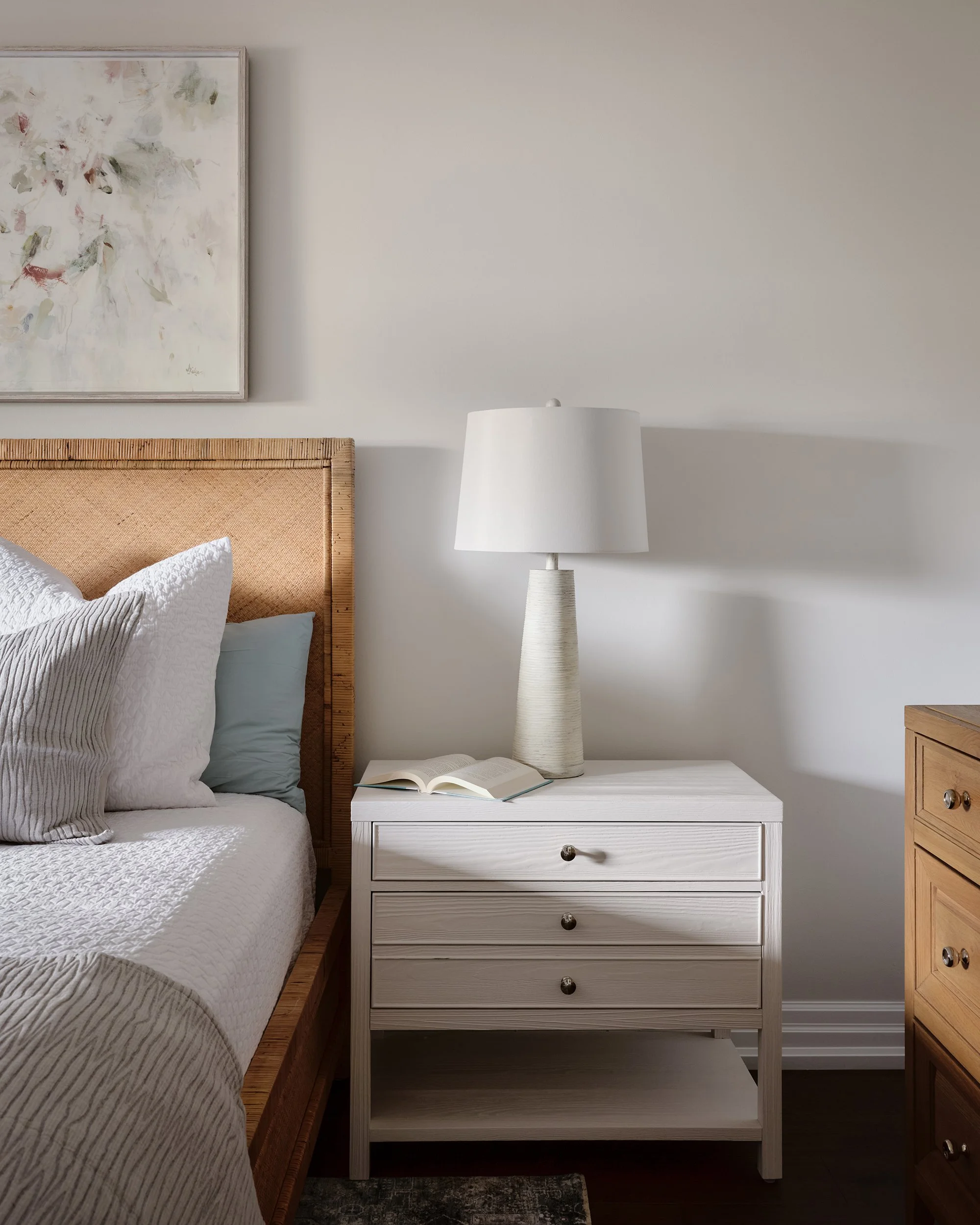 Principal bedroom renovation for an Ottawa family home featuring large white nightstands and textured lamps.