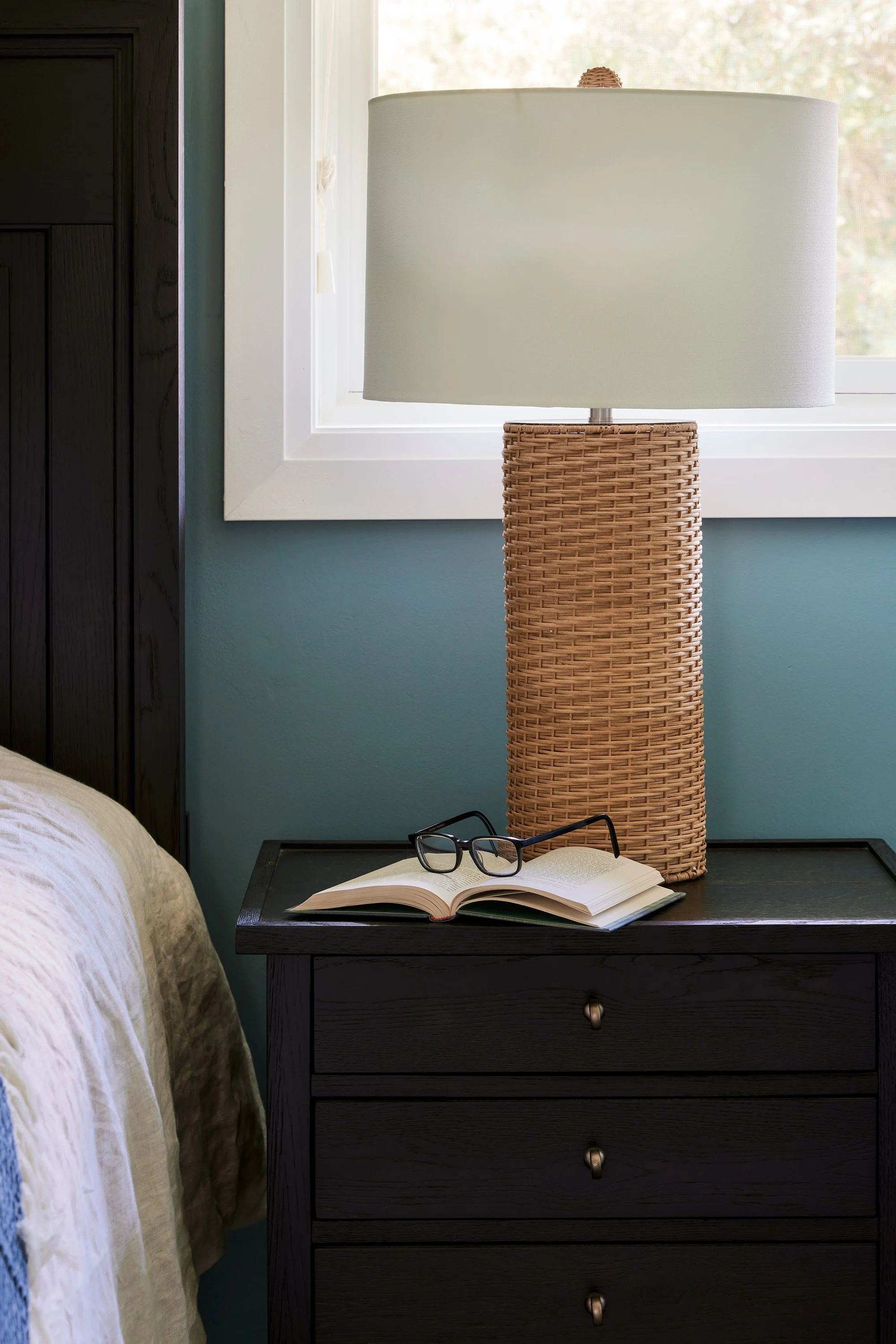 Principal bedroom design for an Ottawa family home featuring a woven table lamp.
