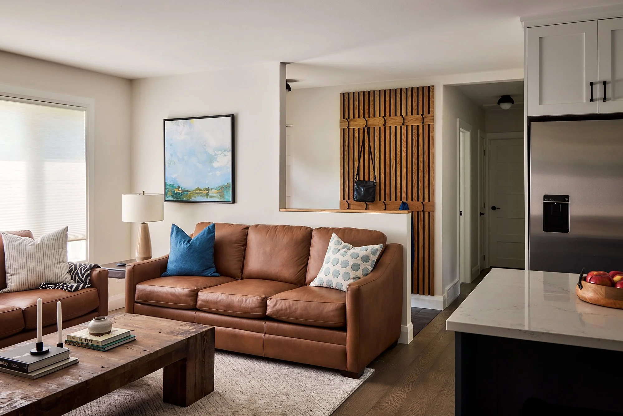 Open concept home design for an Ottawa family home featuring 2 cognac leather sofas for ample seating. 