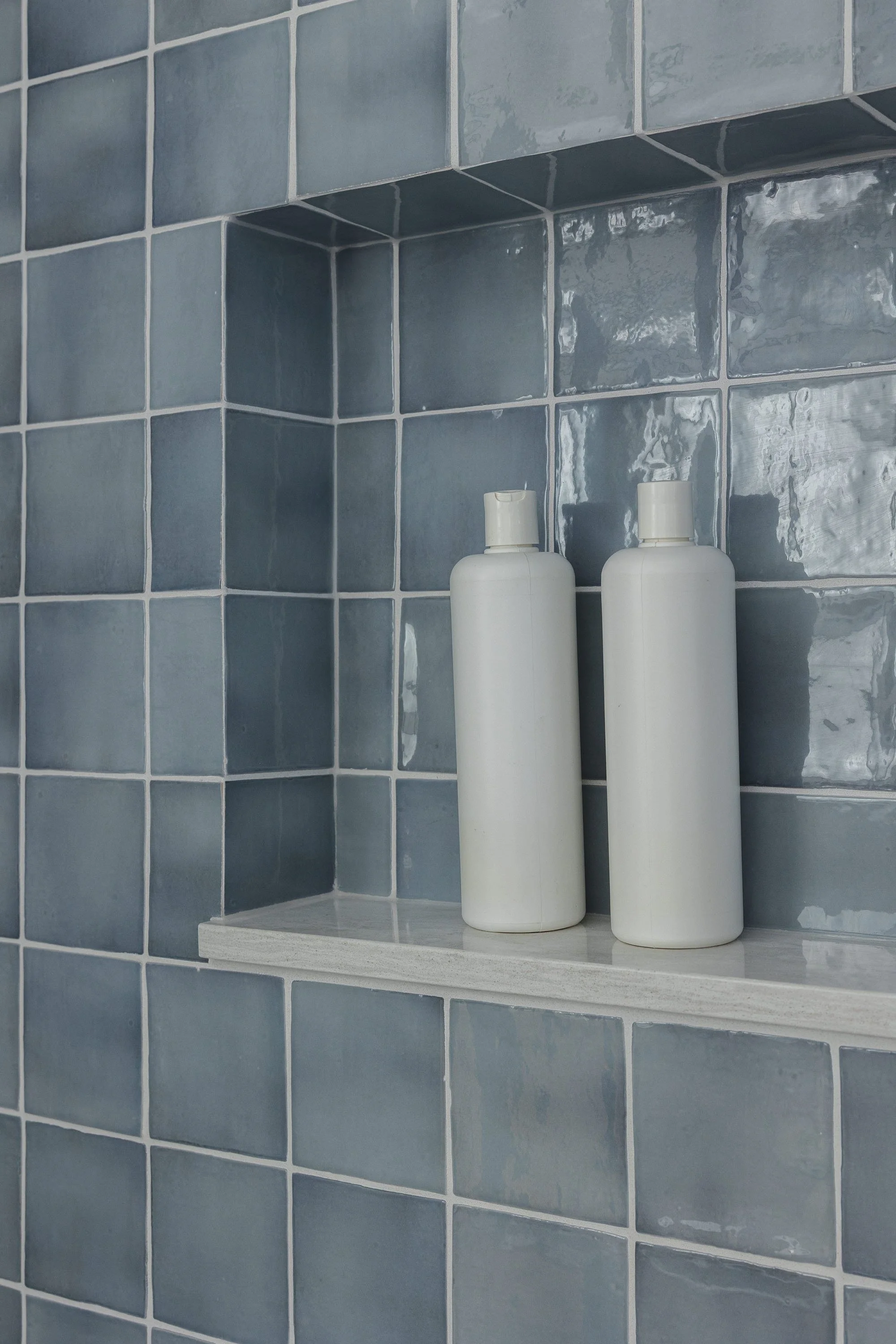 Bathroom renovation in Ottawa featuring tile in the niche with a quartz ledge.