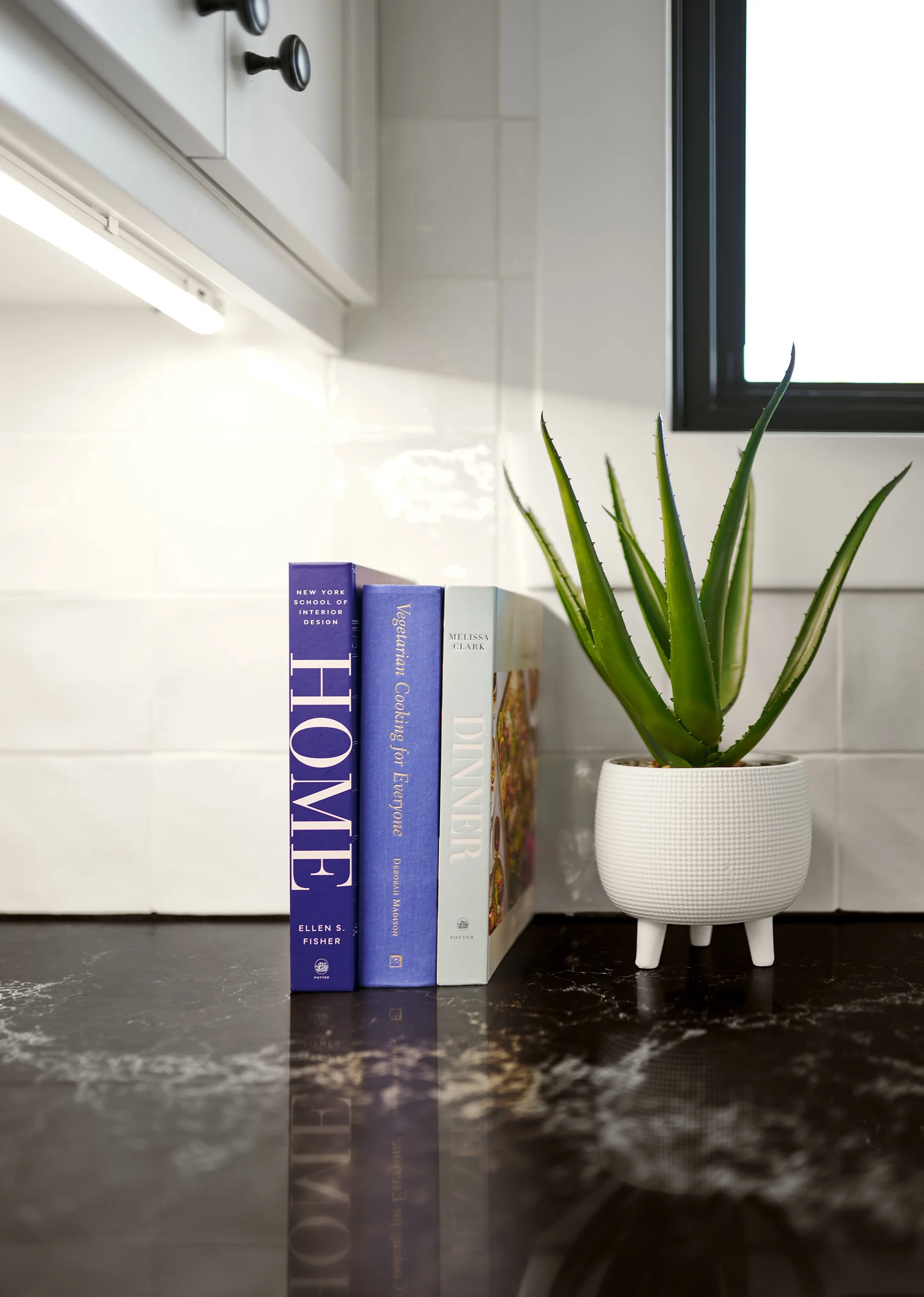 Custom craftsman style kitchen renovation in Ottawa featuring a square texture backsplash and black quartz counter. 