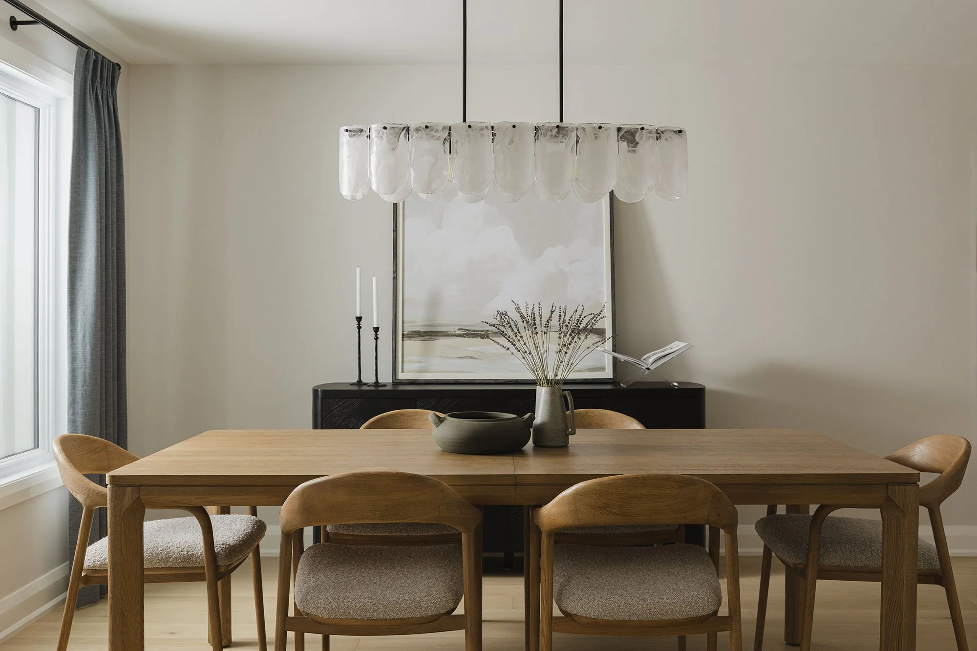 Kitchen renovation in Ottawa featuring a dining room with custom drapery and a white oak table and chairs. 