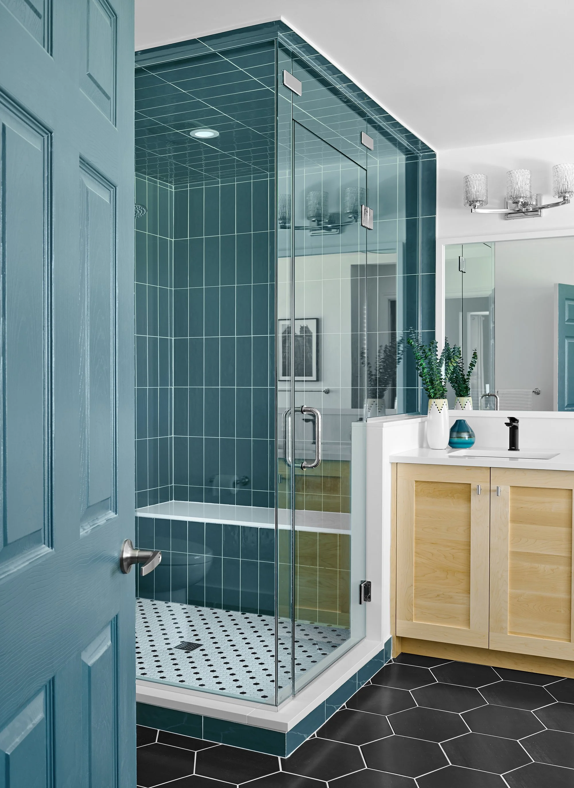 Custom ensuite renovation in Ottawa featuring teal tile in the shower that matches their adjoining closet. 