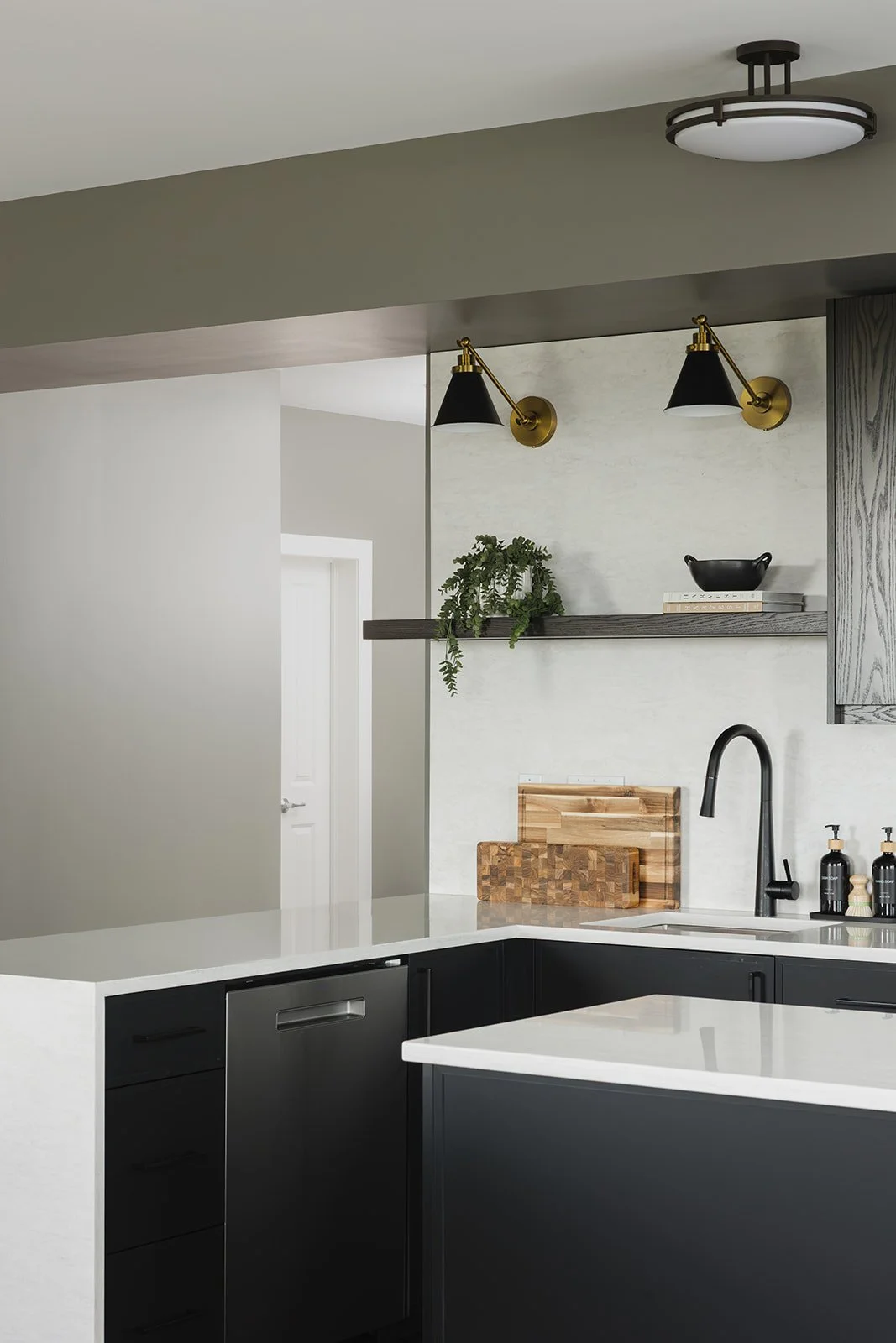 CPI Interiors Ottawa kitchen design with black cabinets and floating shelves
