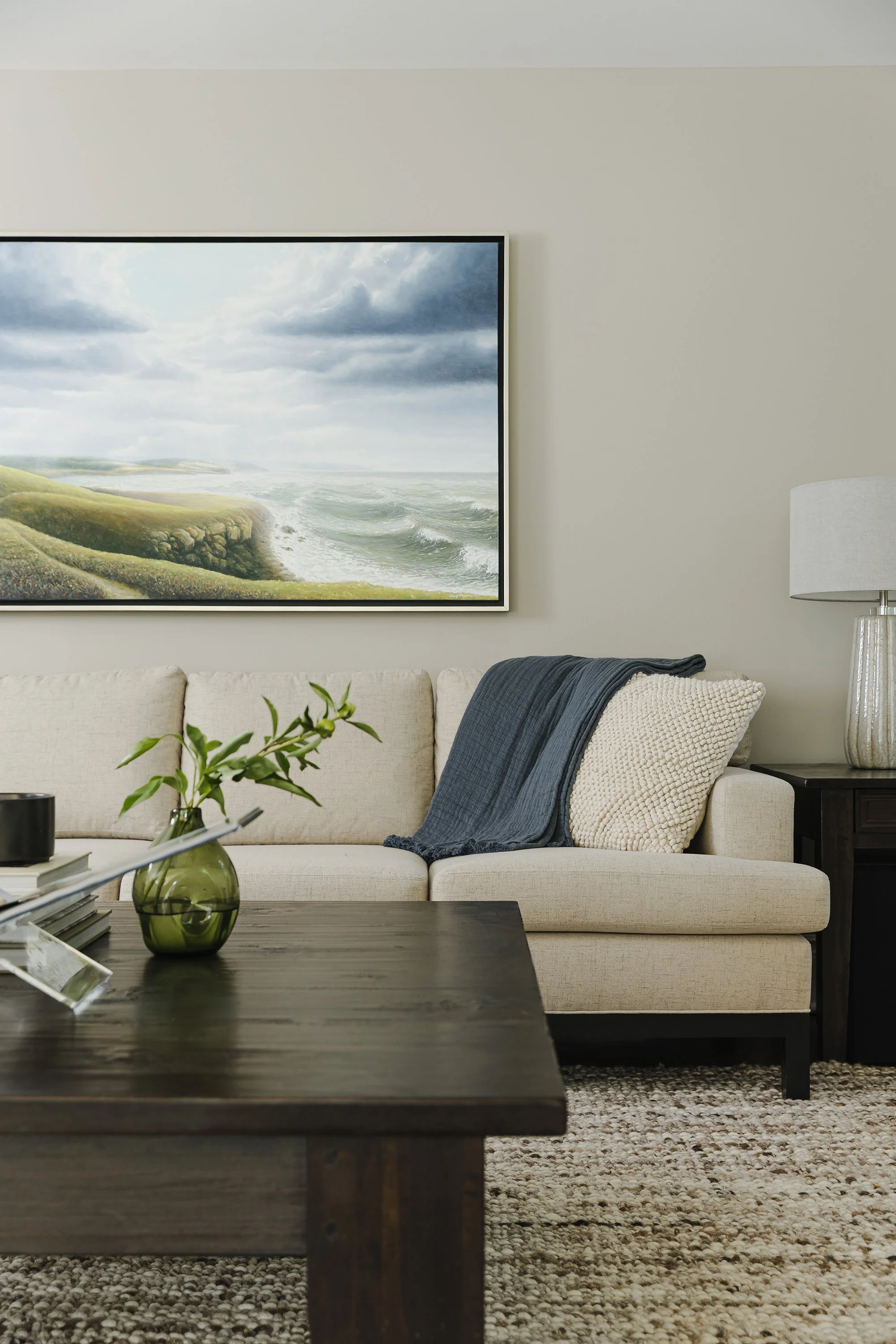 Family room design for an Ottawa family home featuring custom upholstery, a textured wool rug and beautiful accessories. 