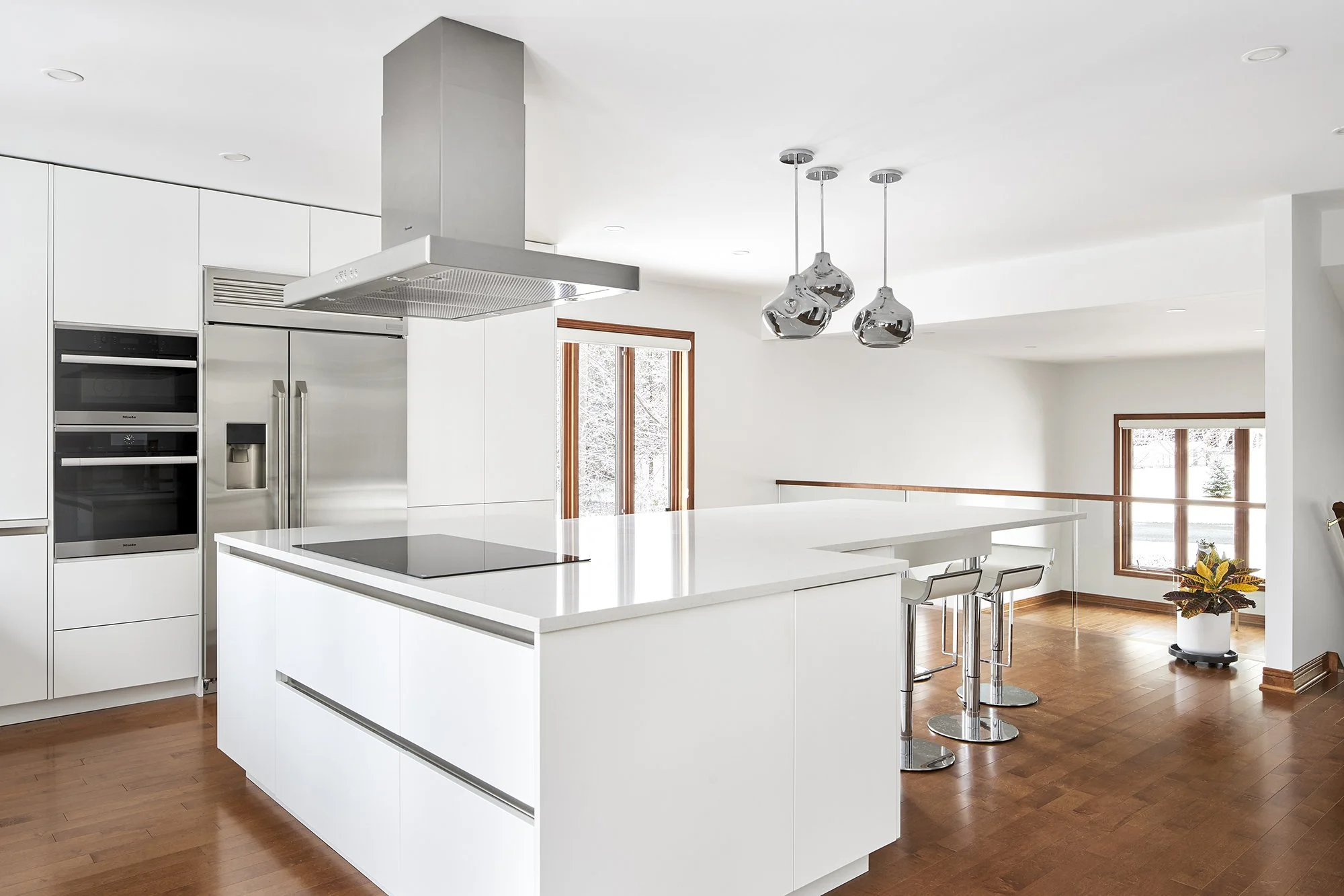 Modern custom kitchen renovation in Ottawa featuring flat panel cabinets and built-in appliances.