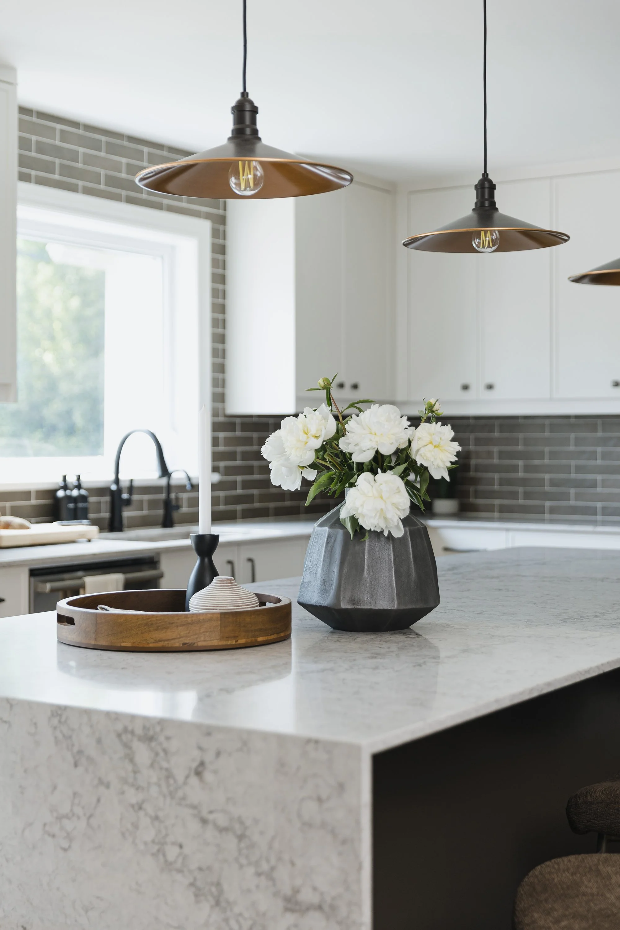 Custom kitchen design for an Ottawa family home featuring a waterfall counter on the island.