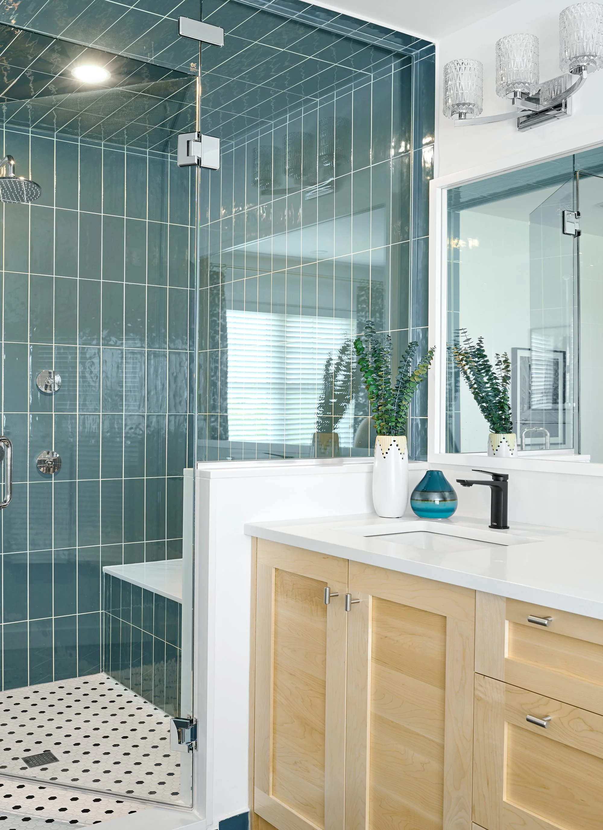 Ensuite renovation in Ottawa featuring a teal custom shower with a bench. 