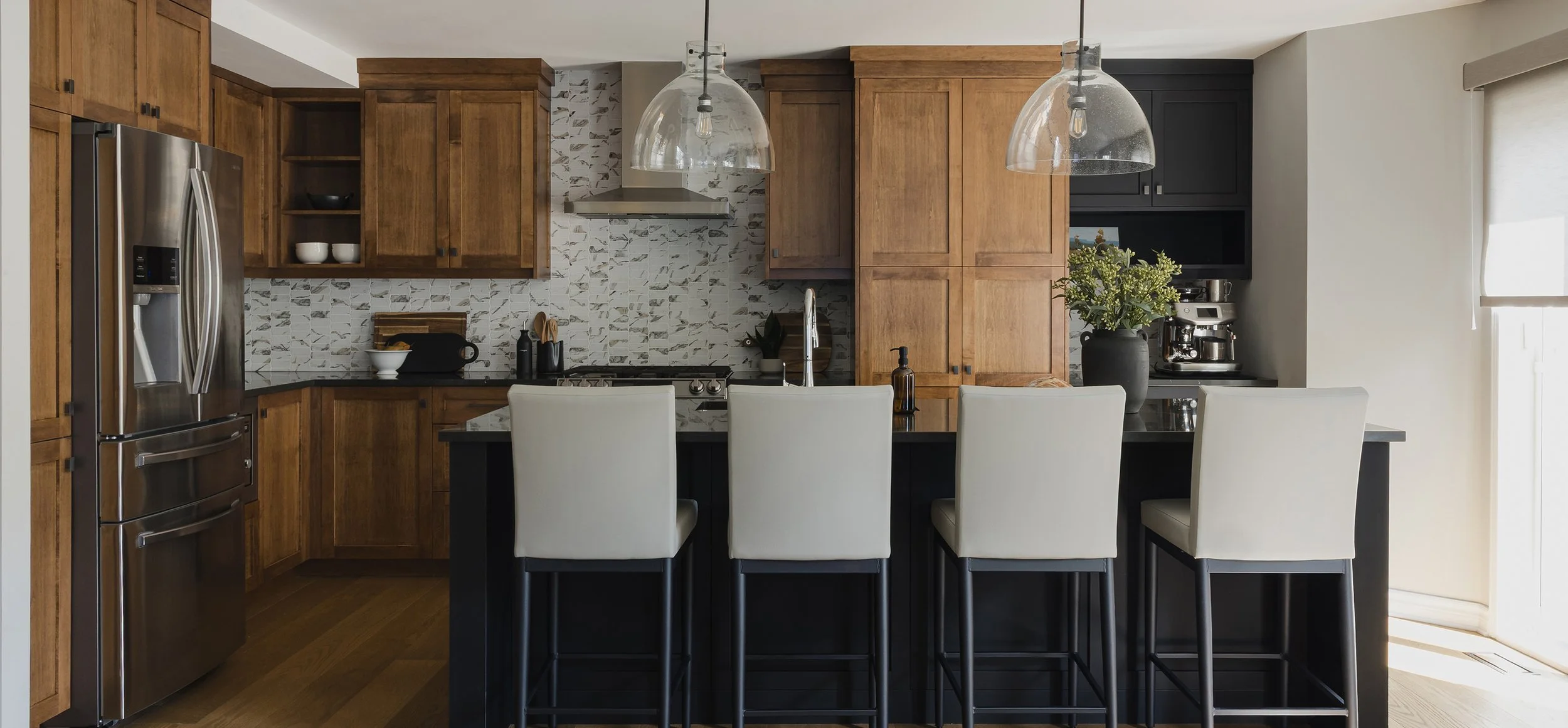 Custom kitchen design for an Ottawa family home featuring maple cabinetry and a black countertop.