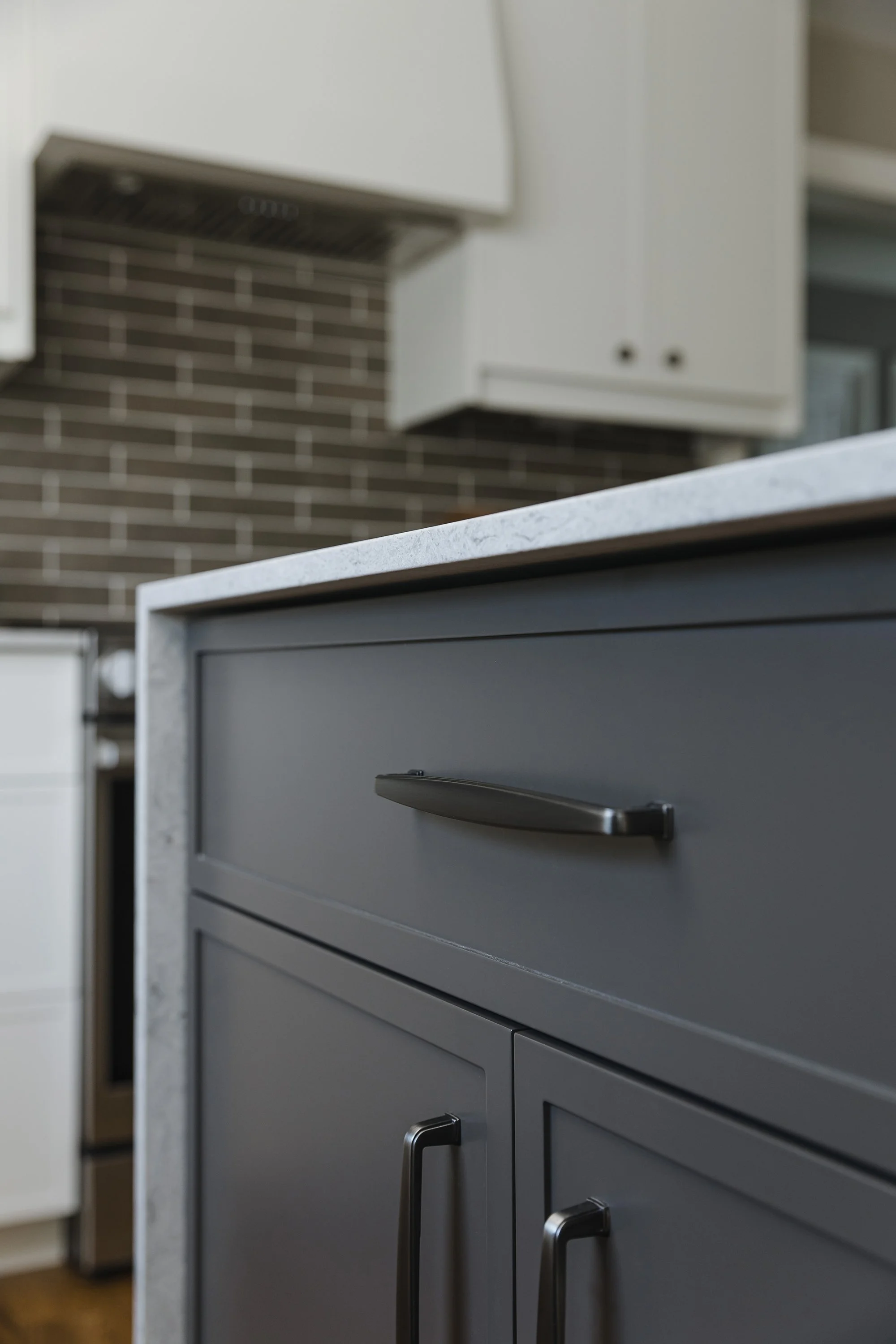 Custom kitchen design for an Ottawa family home featuring a rich brown island