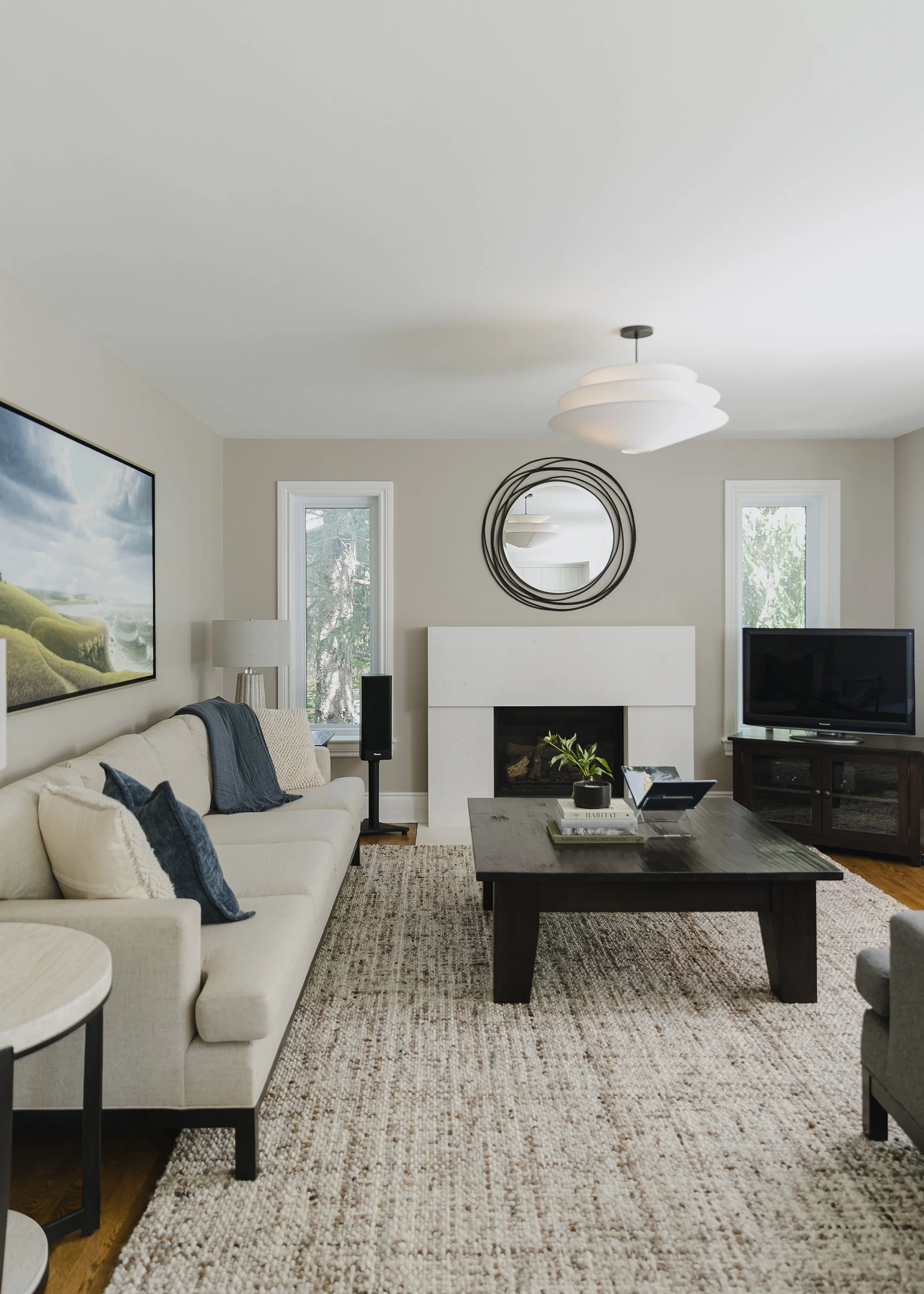 Family room design for an Ottawa family home featuring custom upholstery, a wool rug and beautiful lighting. 