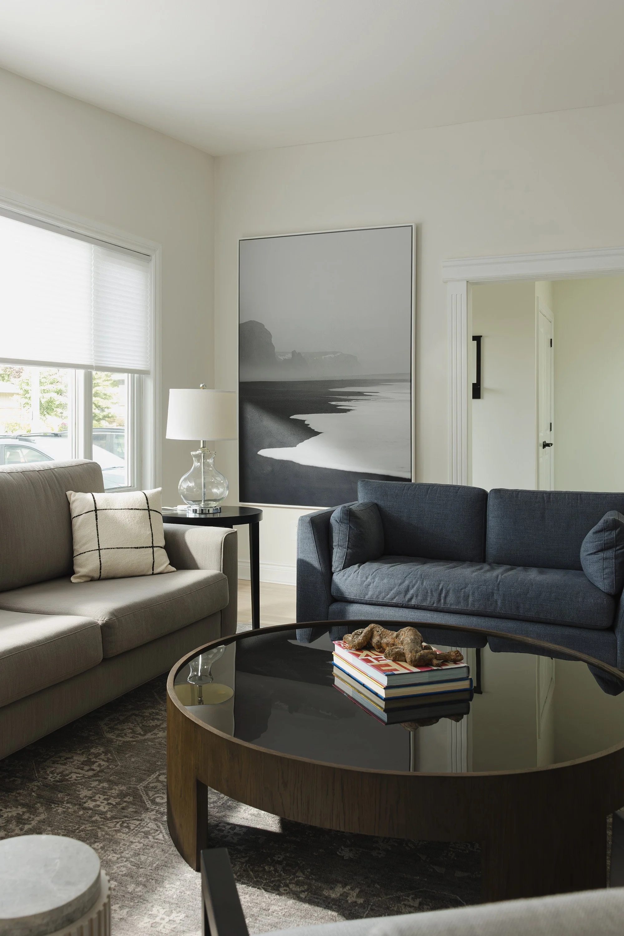 Ottawa interior design featuring custom upholstery with a large round coffee table. 