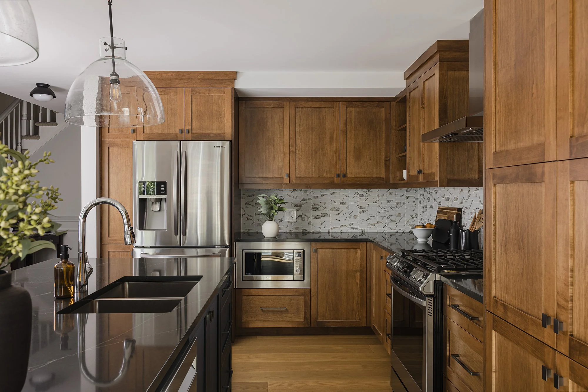 Custom kitchen renovation in Ottawa featuring warm maple cabinets and engineered hardwood floor.