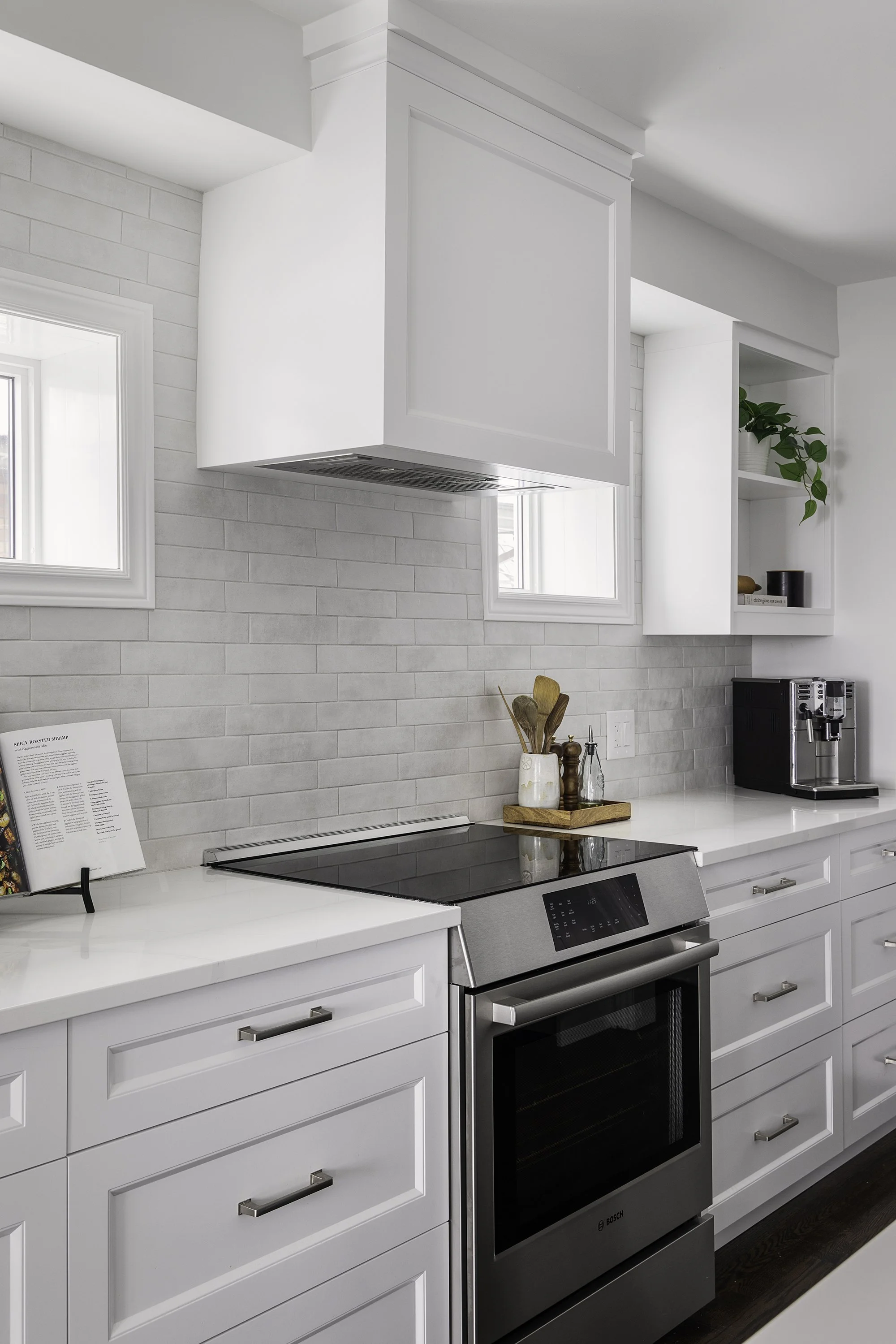 Custom kitchen renovation in Ottawa featuring white shaker cabinetry and a slide in range.