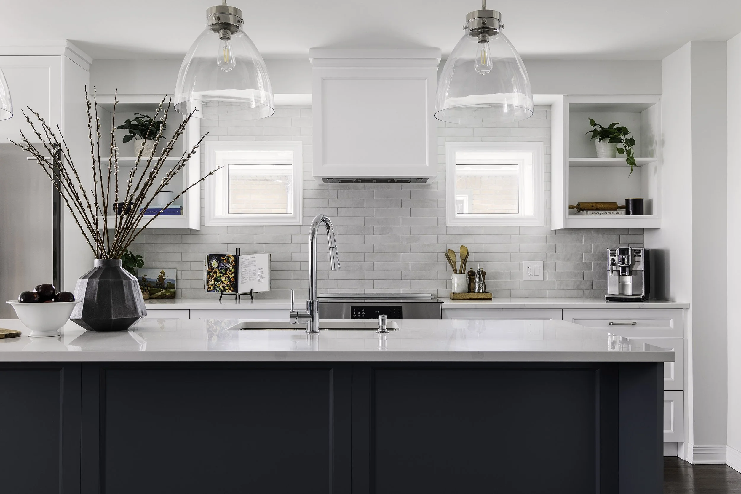 Custom kitchen renovation in Ottawa featuring white shaker cabinets, matte backsplash tile and open cabinets..