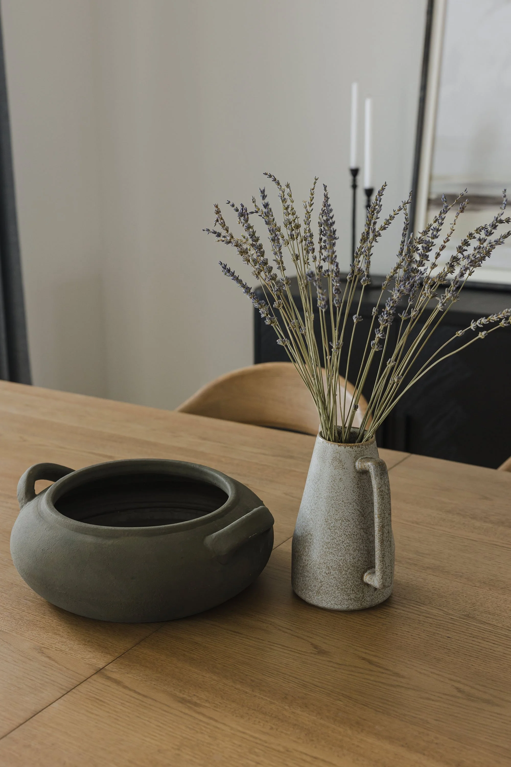 Kitchen renovation in Ottawa featuring a dining room with a white oak table with a bouquet of dried lavender. 