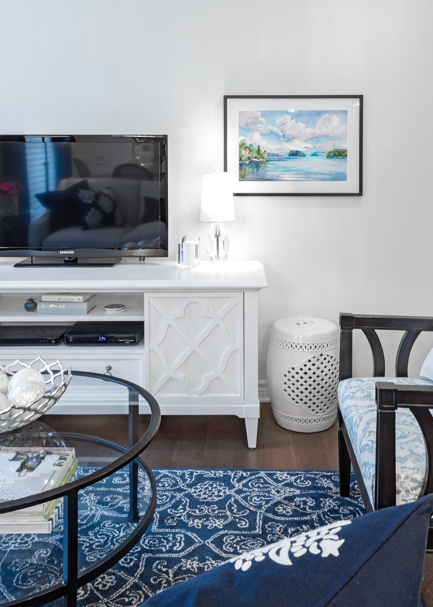 Living room design for an Ottawa condo featuring a wool rug and luxurious entertainment unit