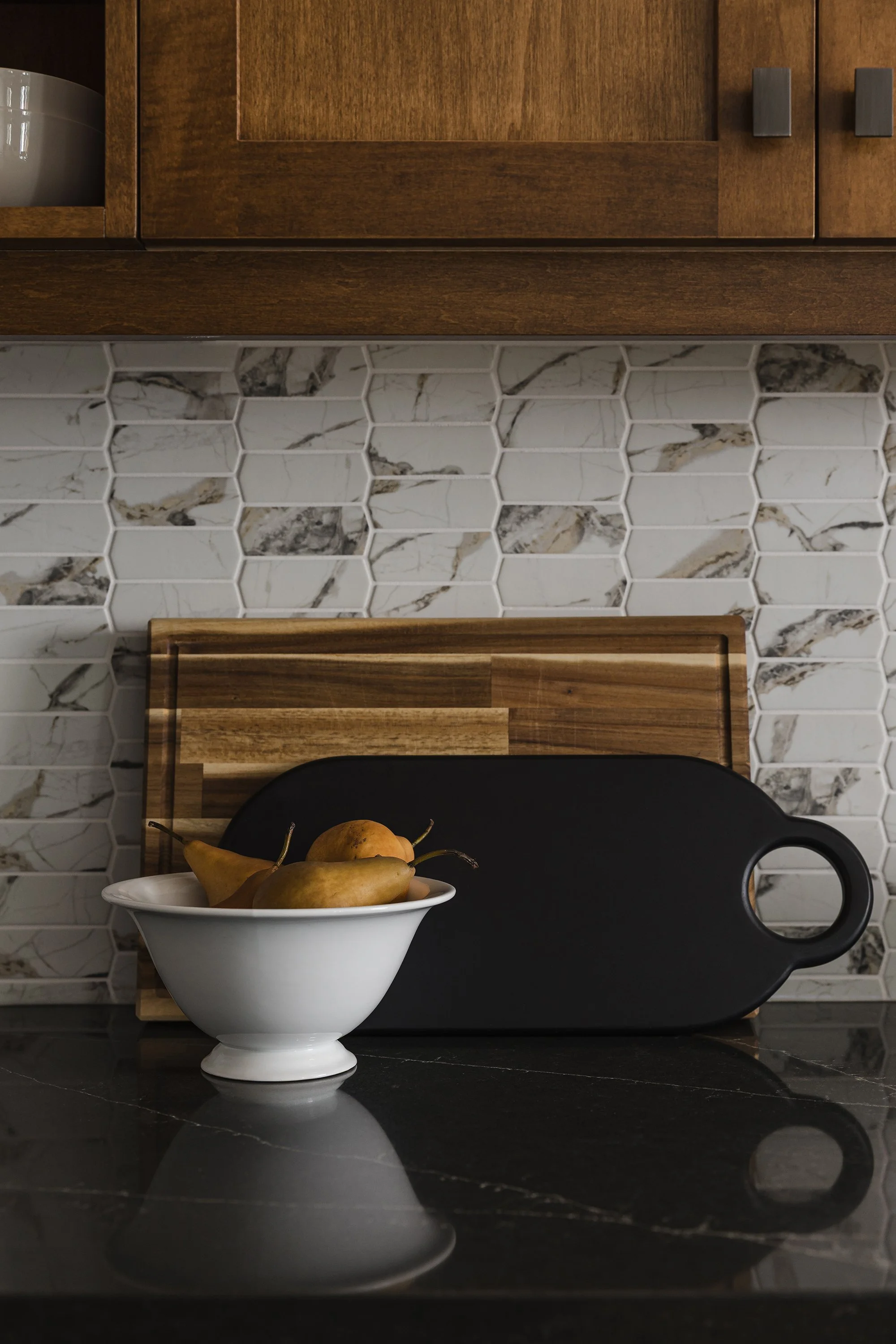 Custom kitchen renovation in Ottawa featuring warm maple cabinets and a recycled glass backsplash. 