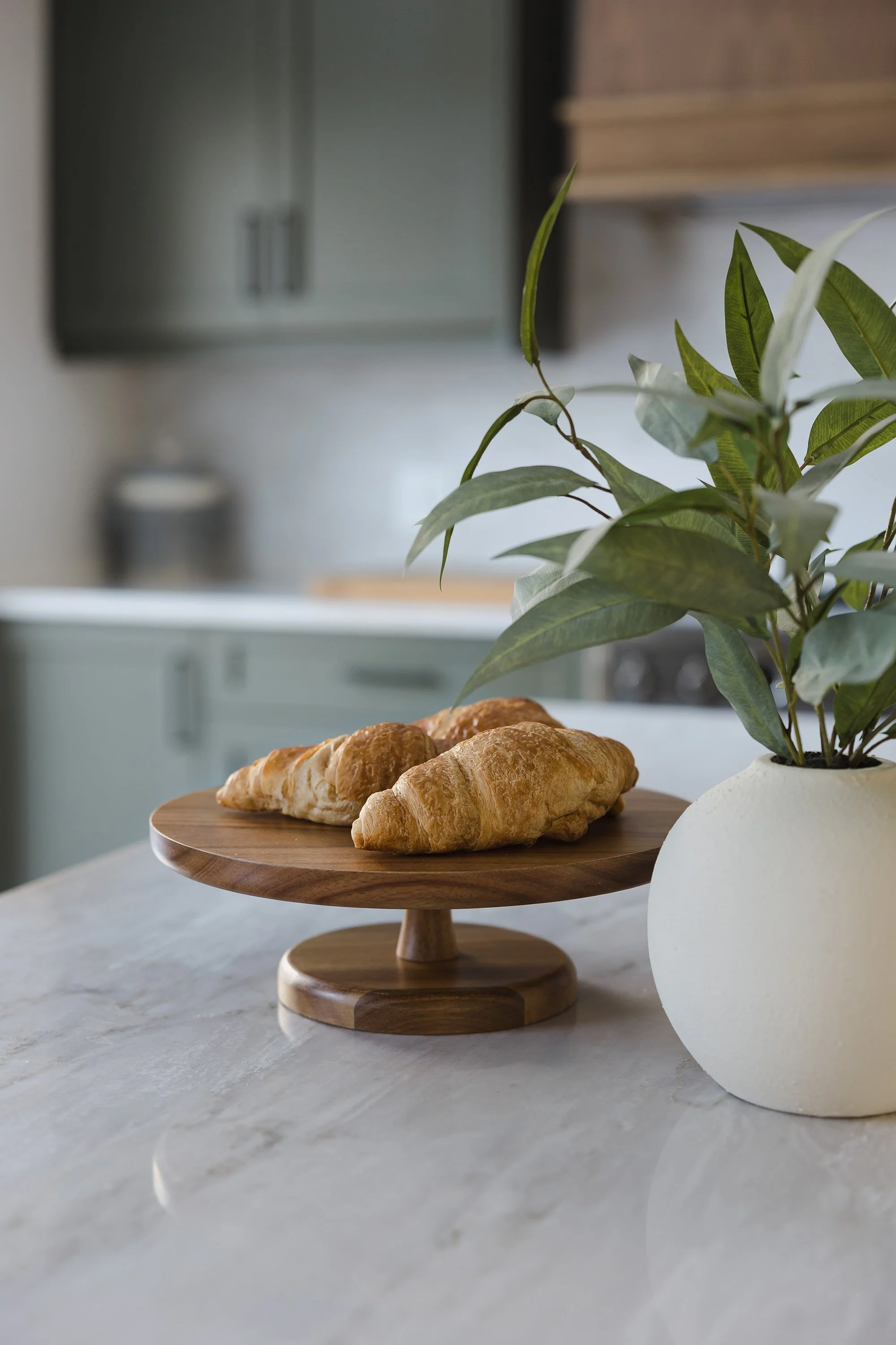 Custom kitchen renovation in Ottawa featuring green shaker cabinets and a beautiful and unique quartz counter. 